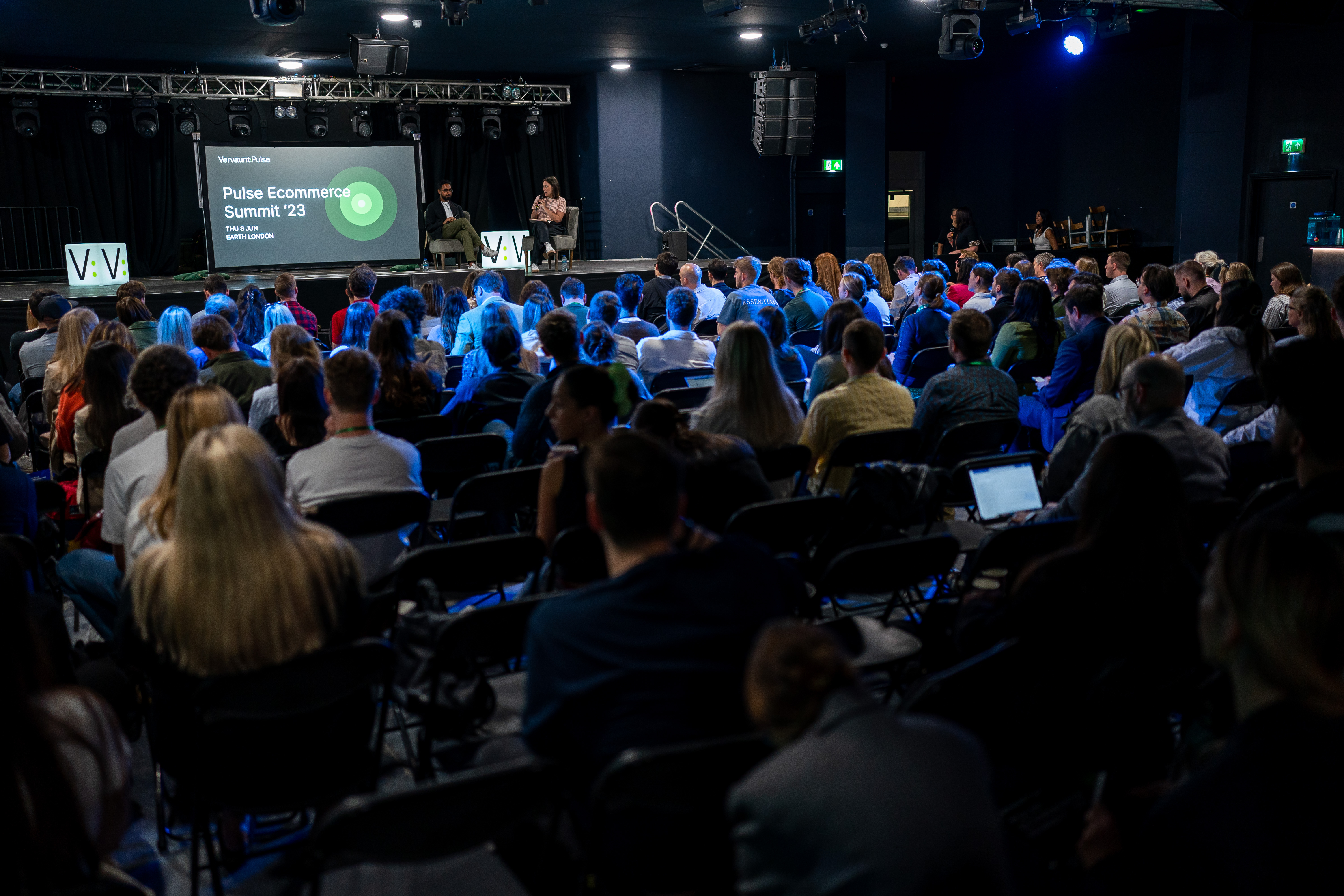 Panel discussion at EartH Theatre with expert speakers and engaged audience.