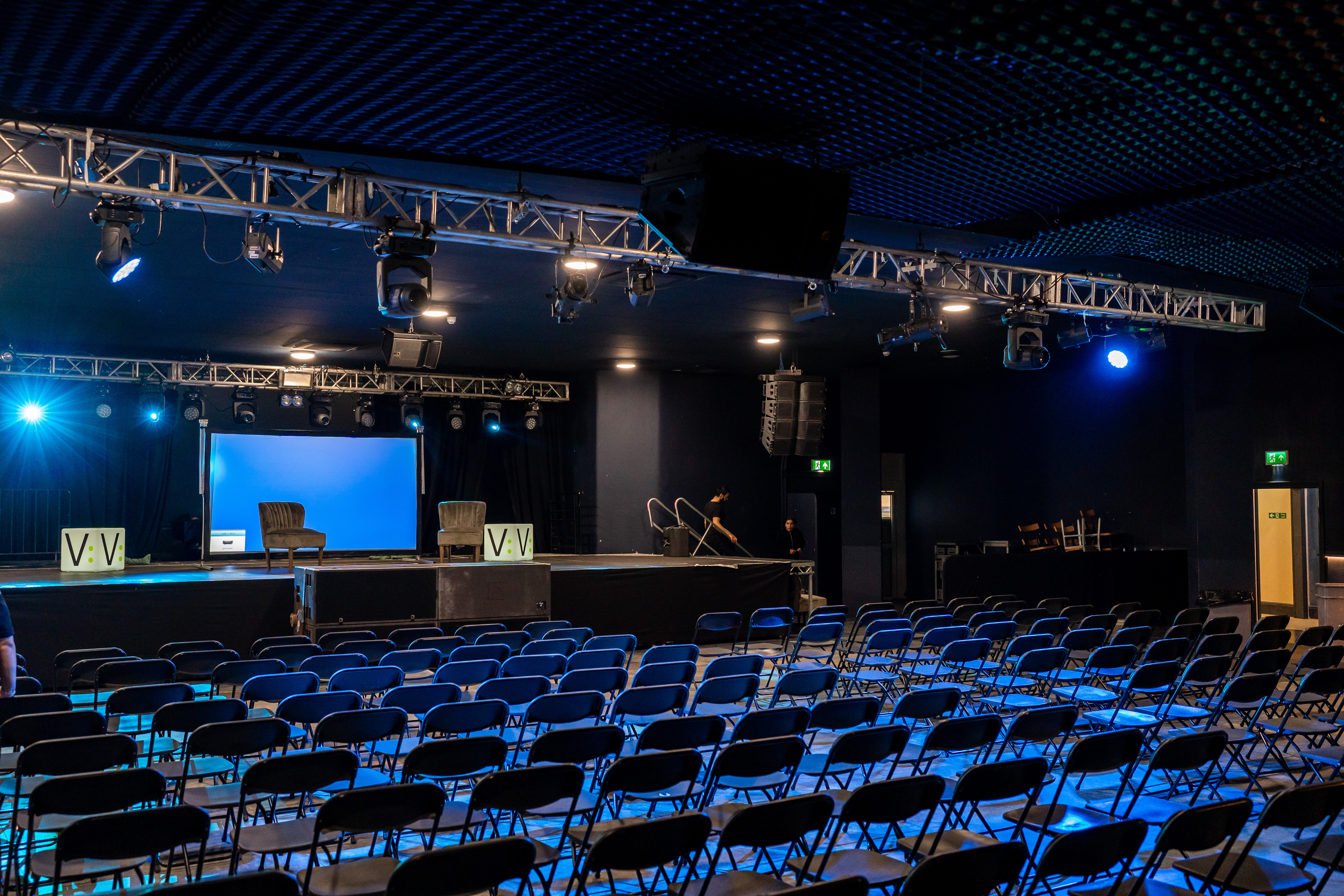 Theatre in EartH with stage lighting, ideal for presentations and panel discussions.