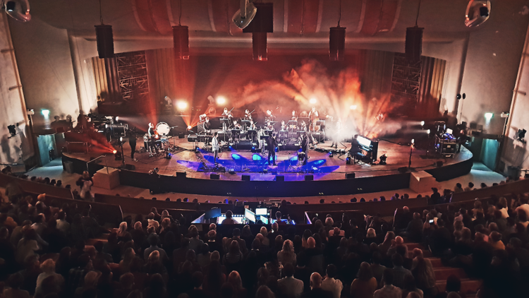 Vibrant live performance at EartH Theatre with dynamic stage and engaged audience.