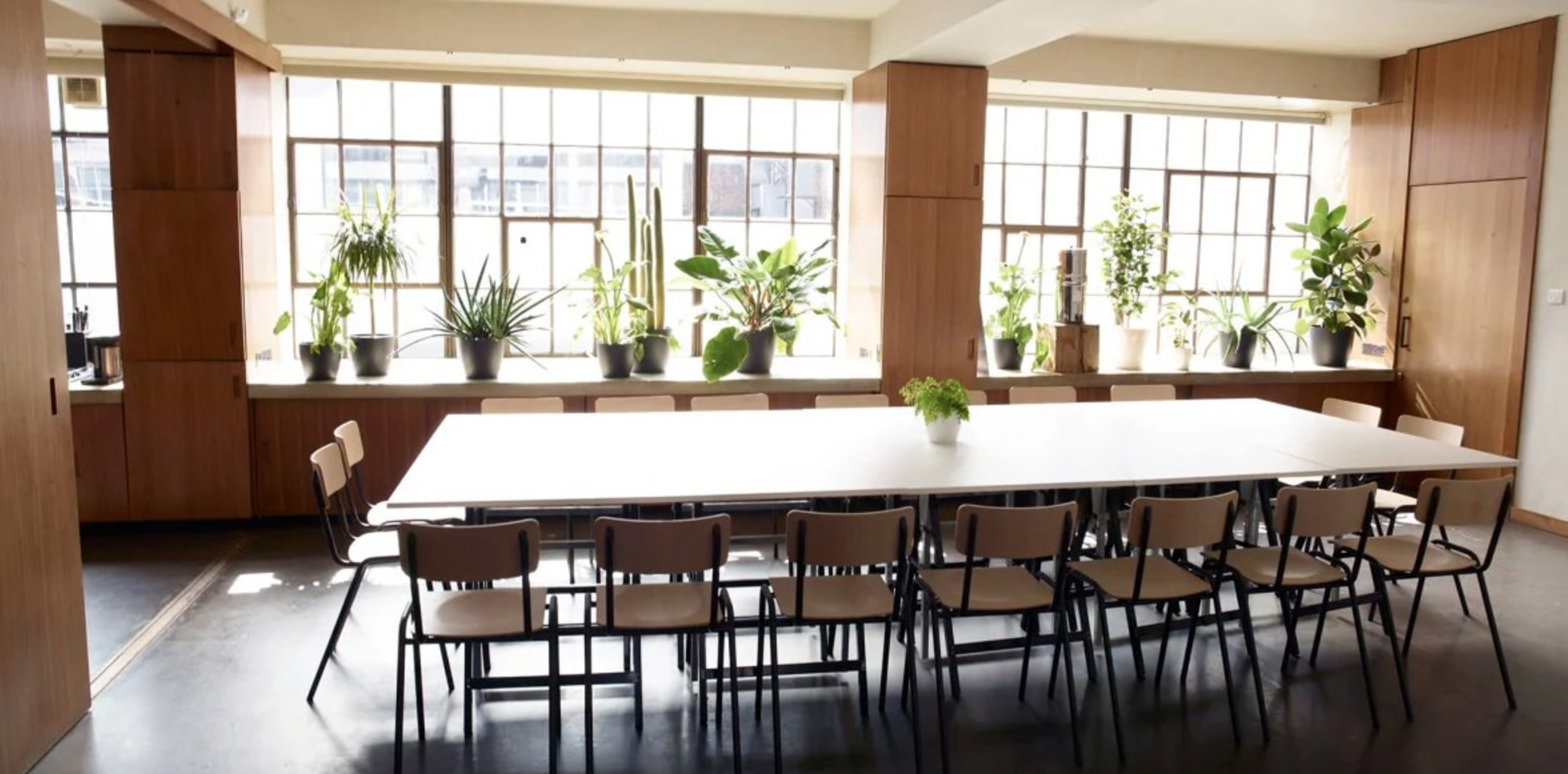 Spacious meeting room with natural light for seminars and workshops at Robert's Place Studios.