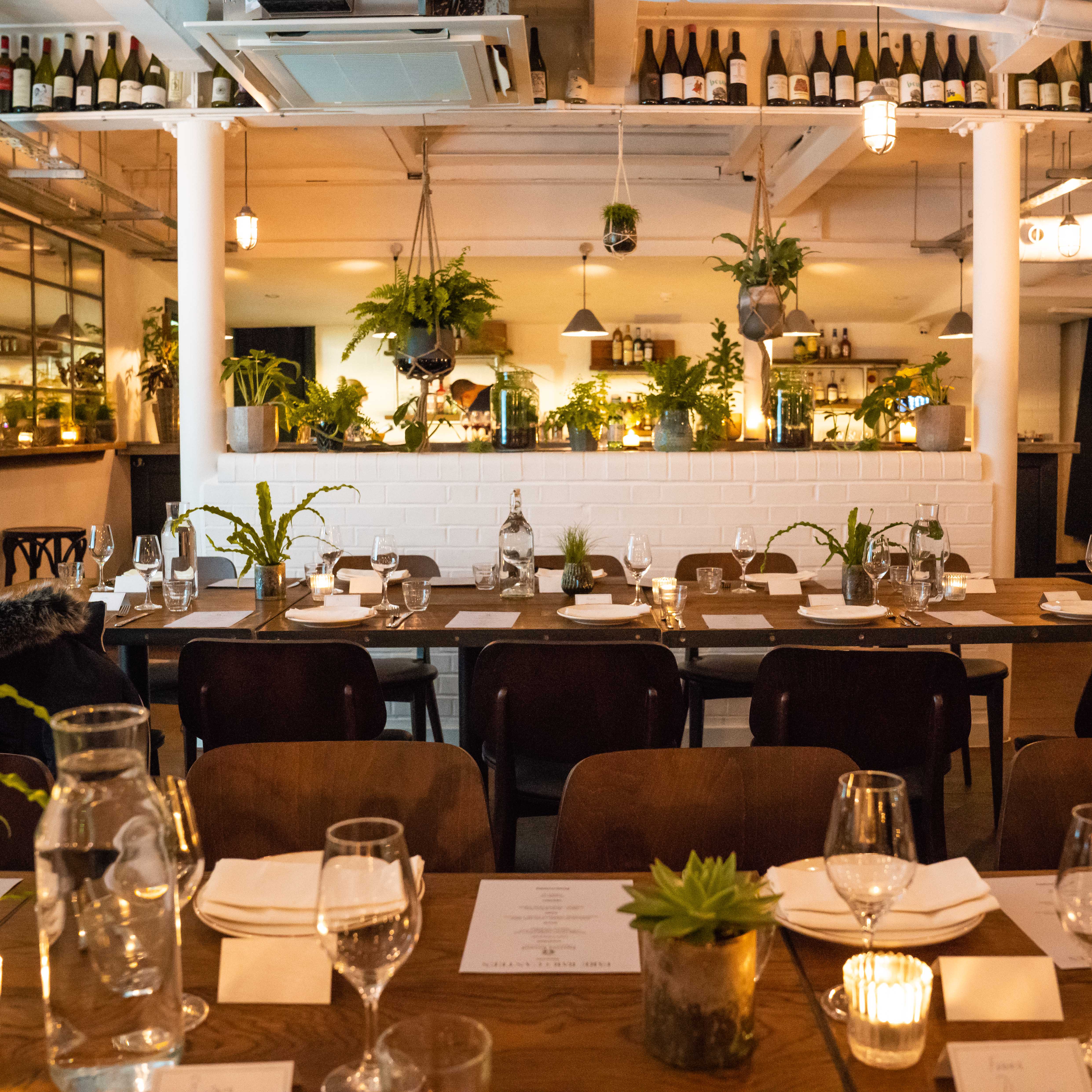 Wine room at FARE Restaurant + Bar, elegant table setup for corporate events and gatherings.