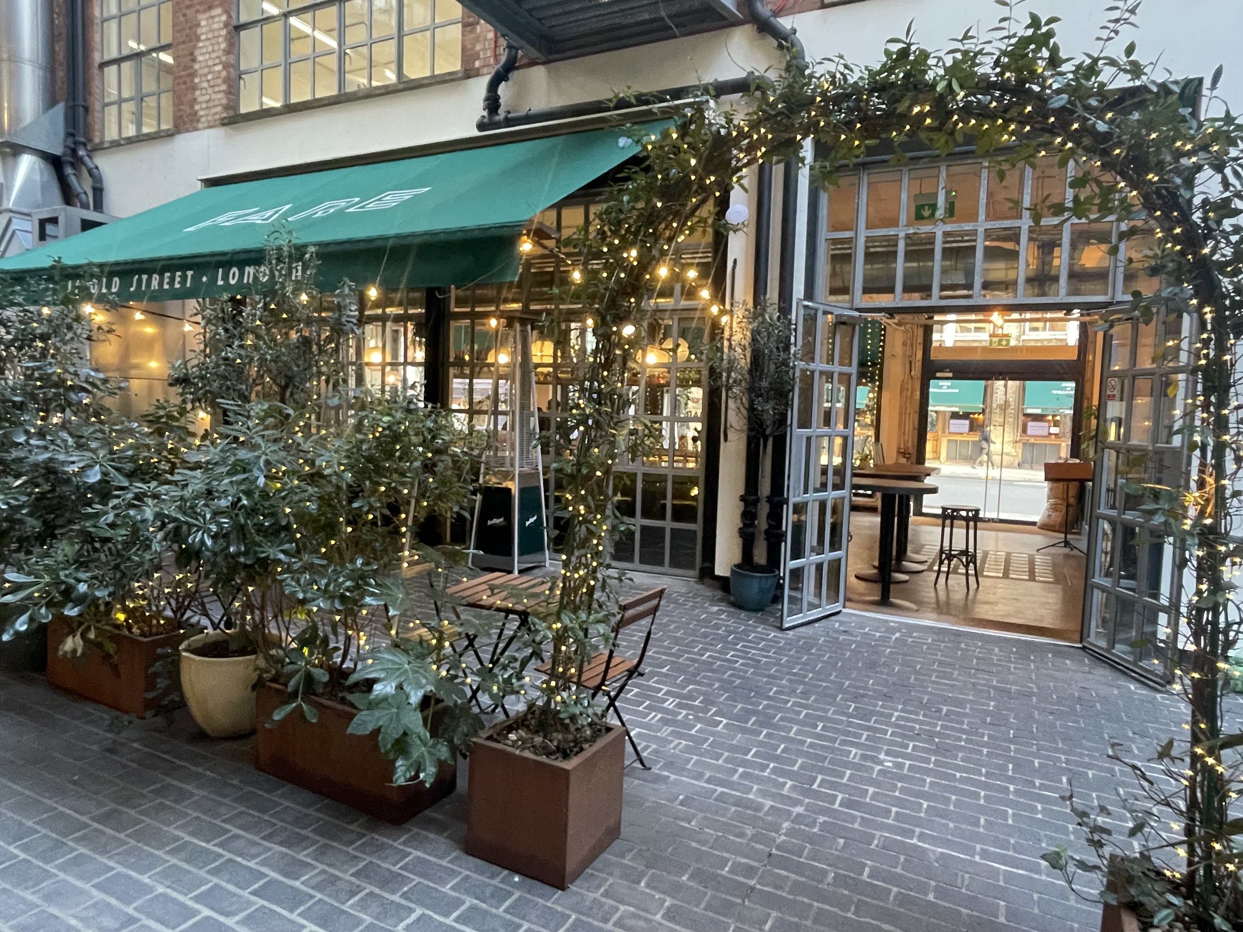 Charming outdoor venue with greenery for networking events at FARE Restaurant + Bar.