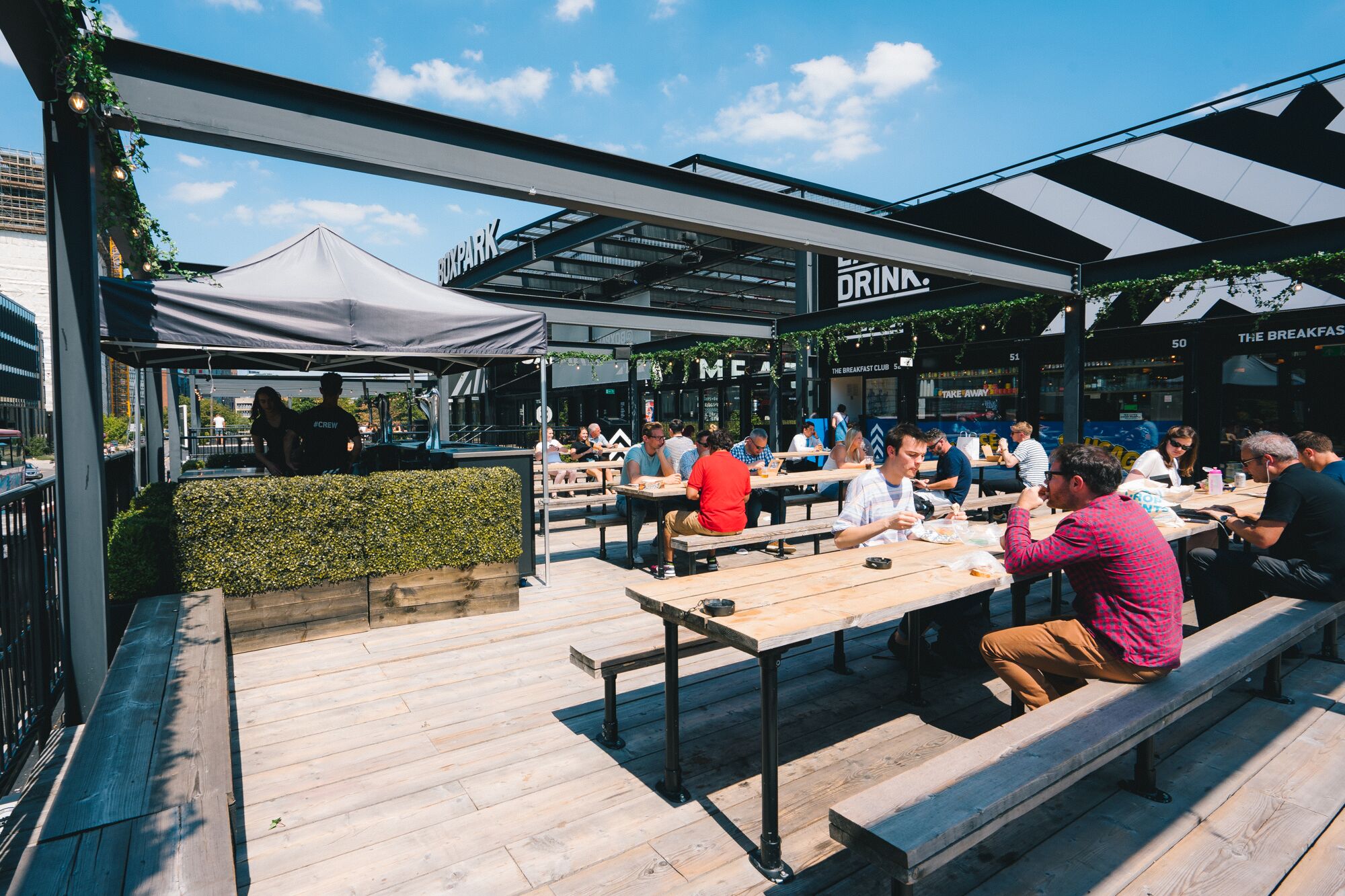 Vibrant outdoor terraces at Boxpark Croydon for casual meetings and events.