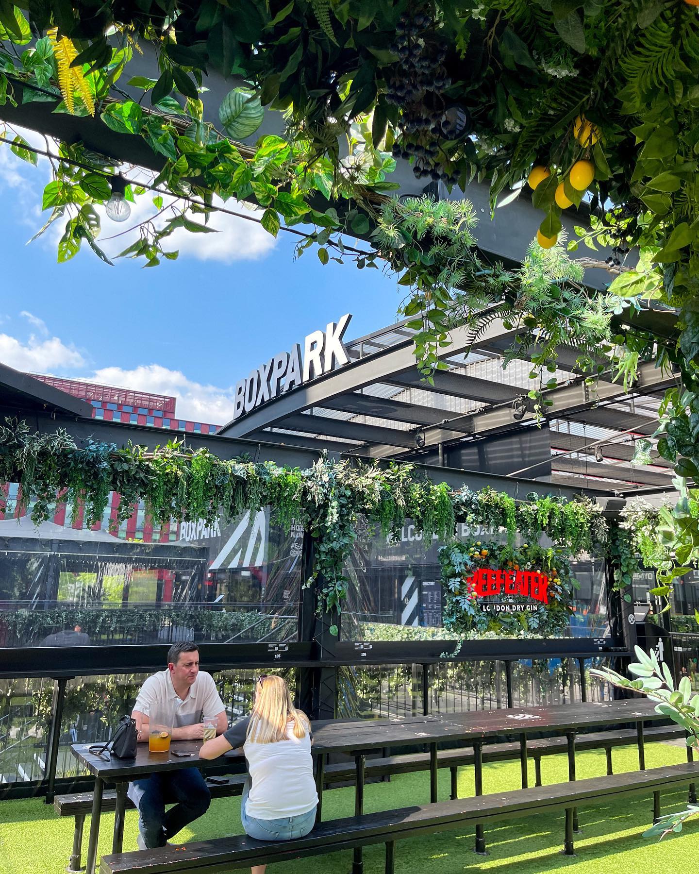 Vibrant outdoor meeting space with greenery at Boxpark Croydon for networking events.