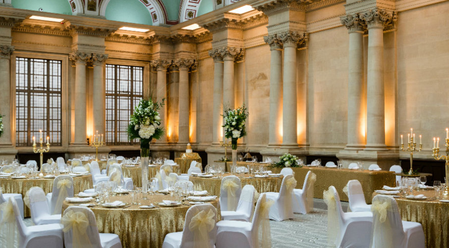 Elegant Sansovino Hall with gold tables, perfect for weddings and formal events.