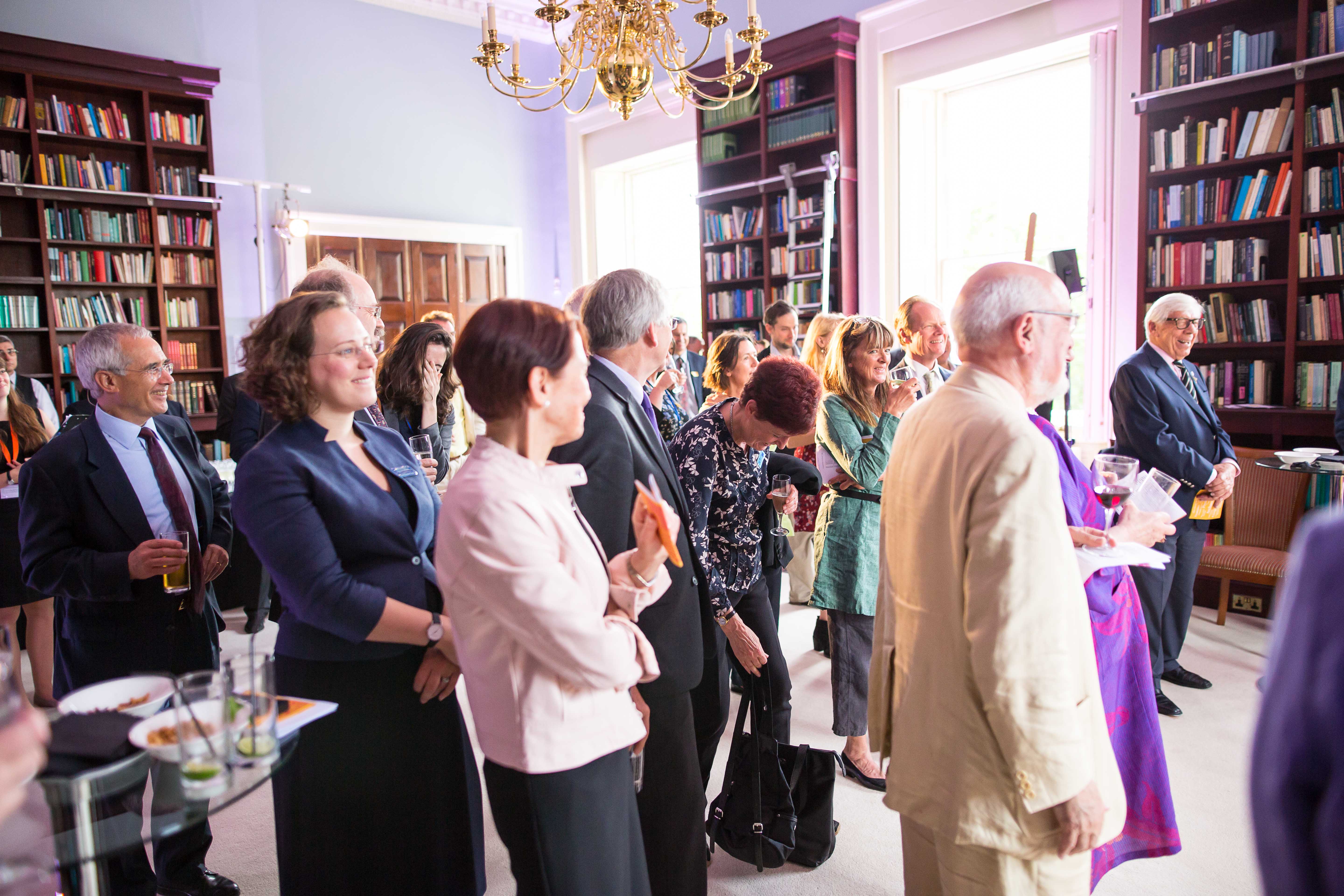 Networking event in The Library, Carlton House Terrace, with elegant bookshelves and lively atmosphere.