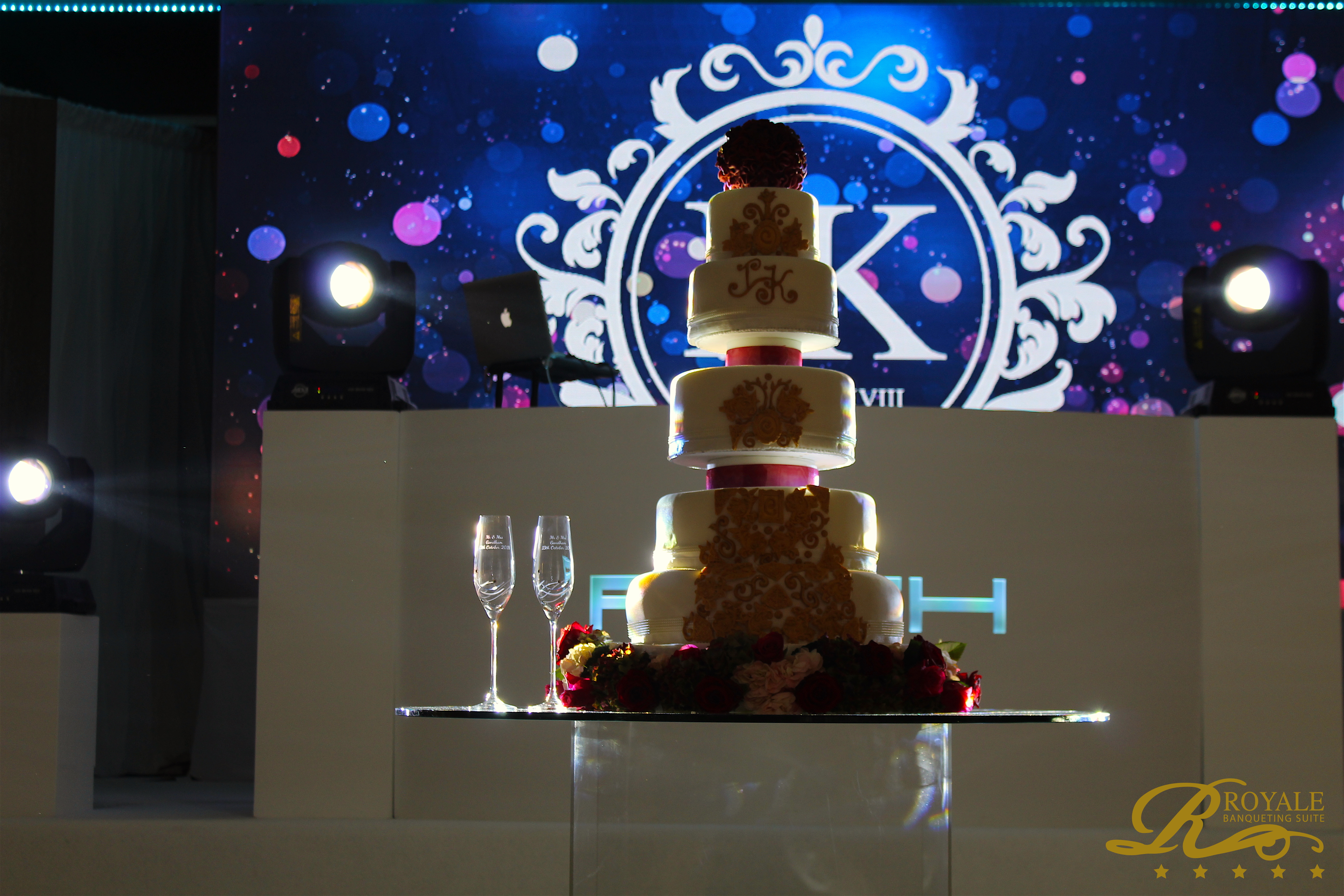 Elegant multi-tiered wedding cake in Royale Banqueting Suite for a sophisticated celebration.