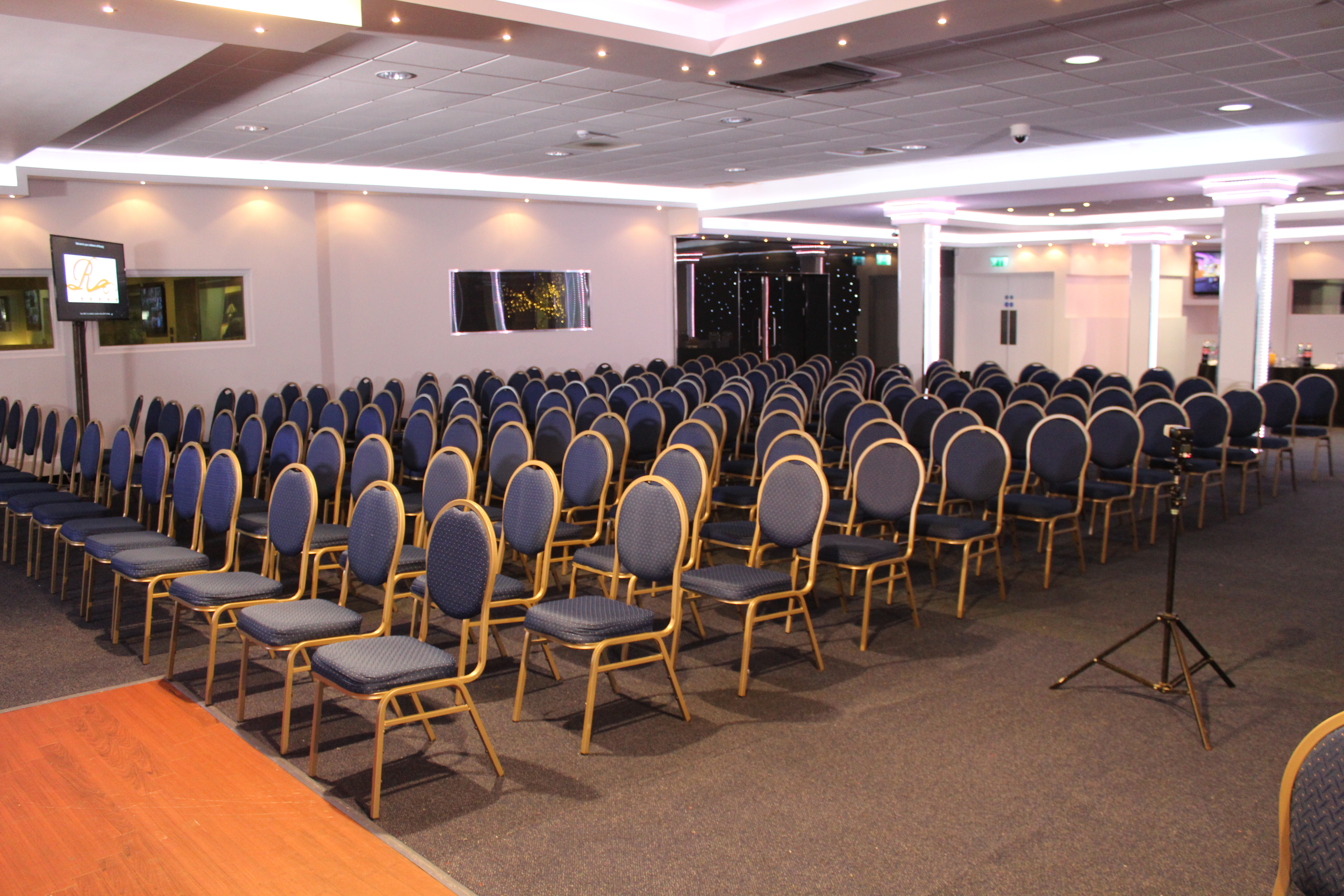 Executive lounge in Royale Banqueting Suite with blue chairs for conferences and seminars.