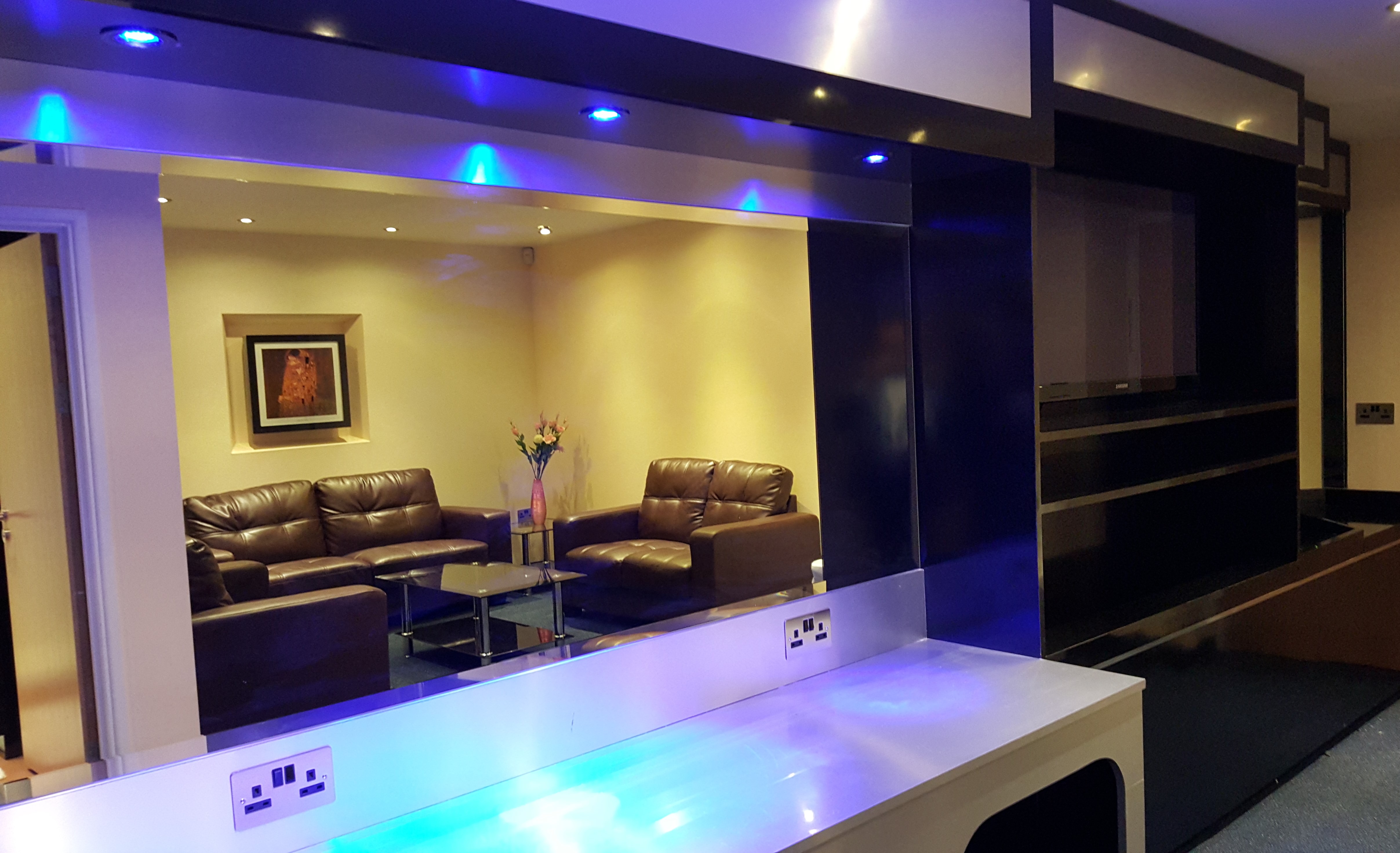Modern executive lounge with ambient lighting for networking at Royale Banqueting Suite.