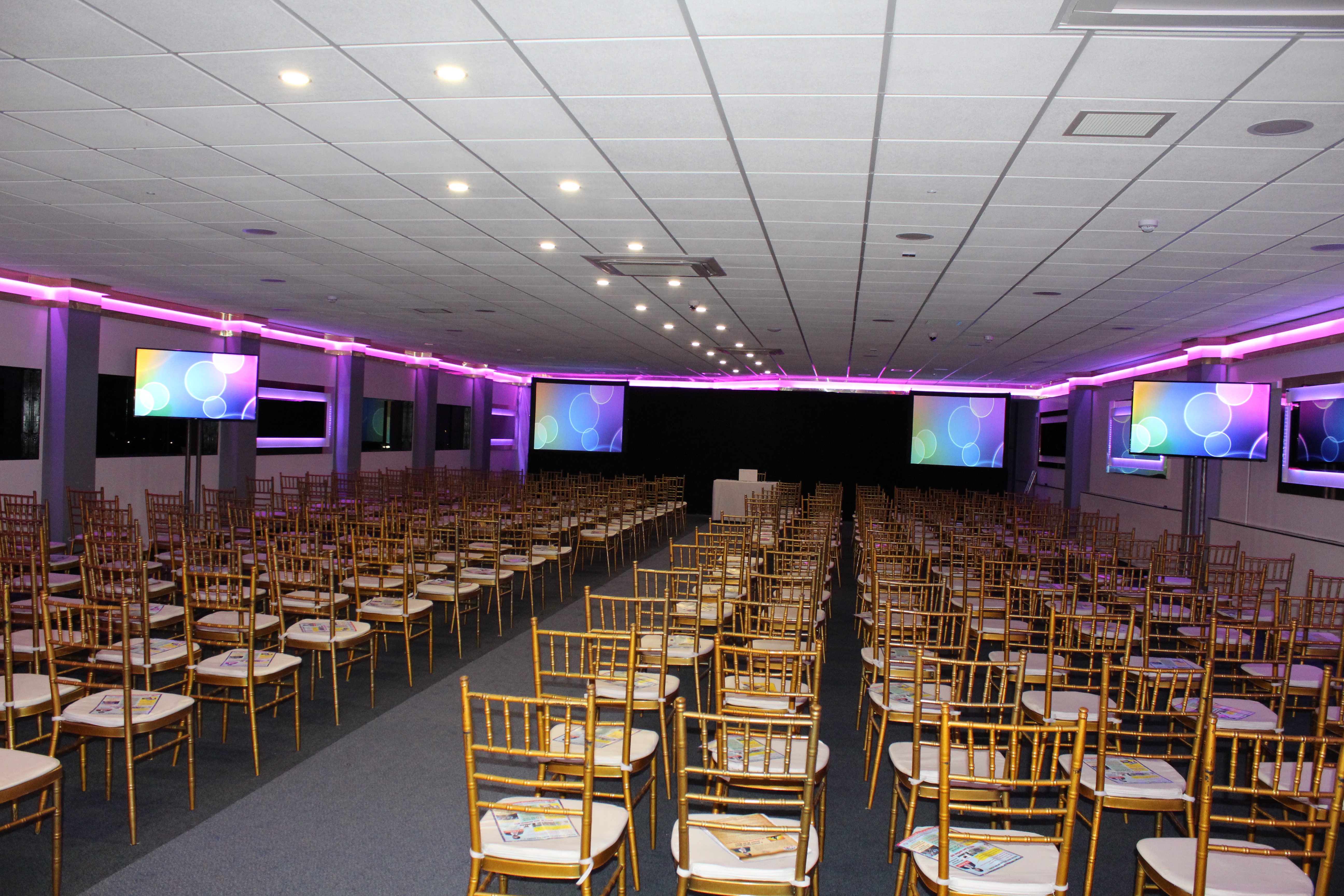 Elegant gold chiavari chairs in Royale Banqueting Suite for conferences and seminars.