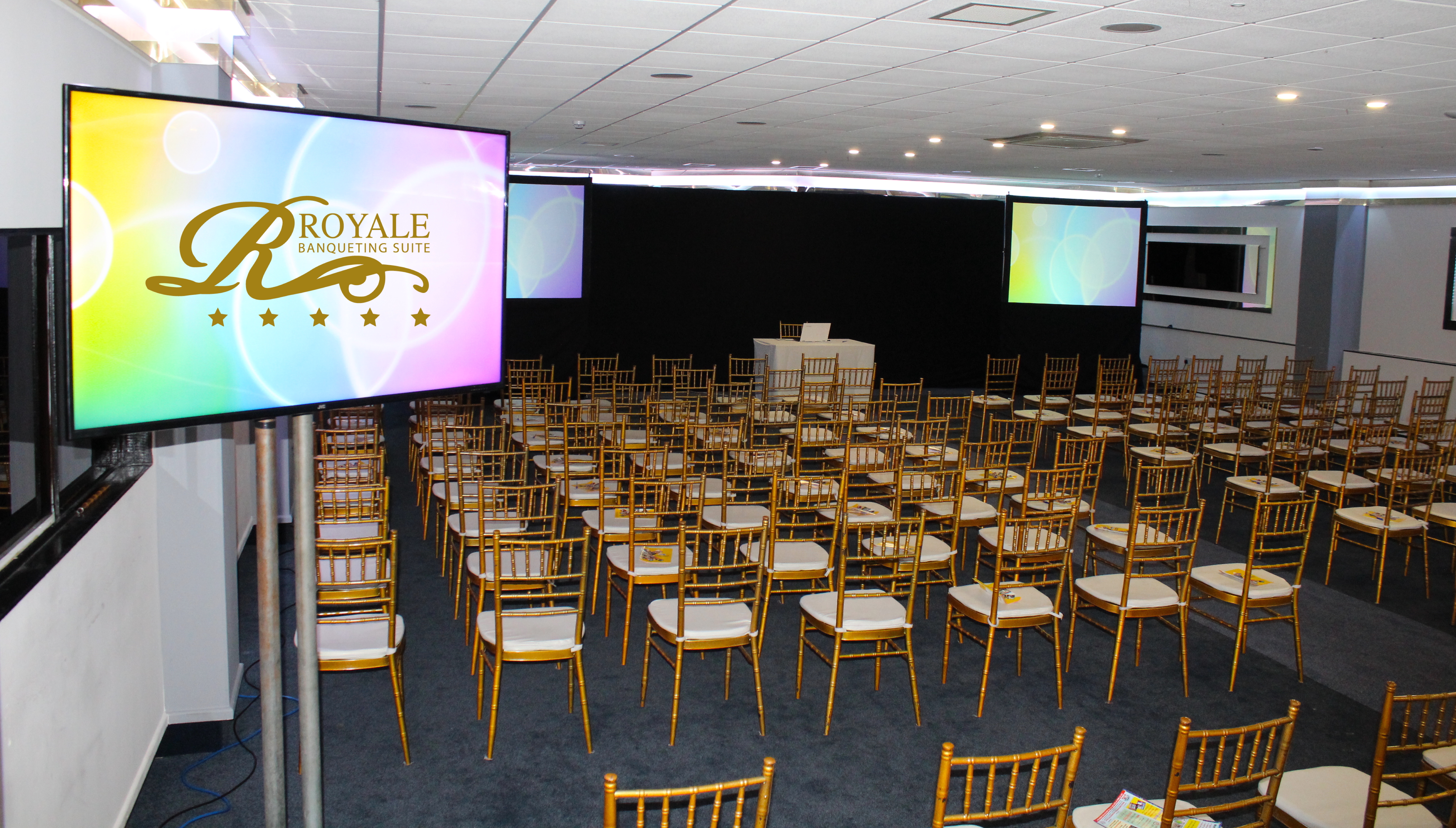 Elegant Golden Suite with gold chiavari chairs for corporate events and presentations.