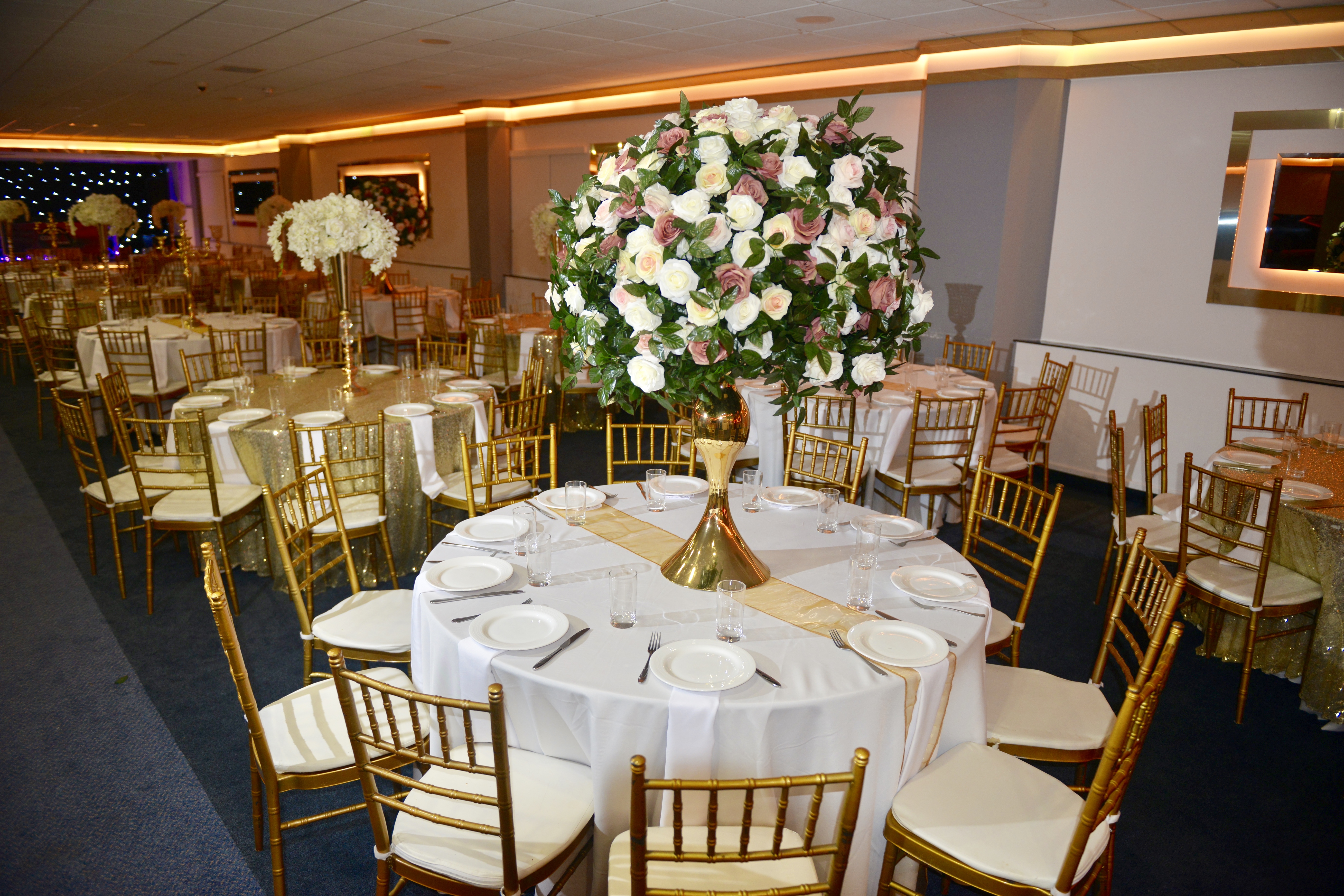 Elegant Golden Suite with floral centerpieces, perfect for weddings and formal events.