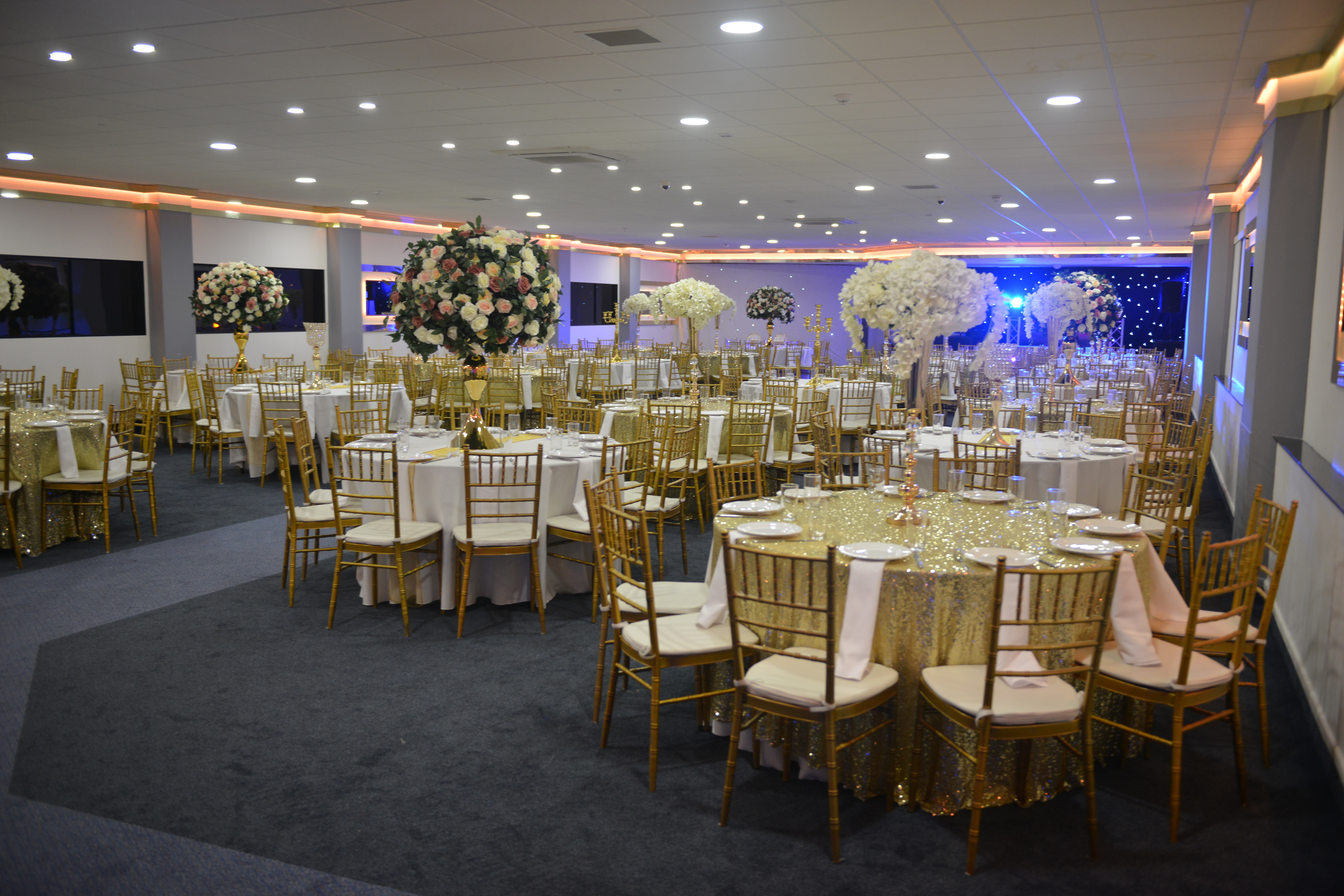 Elegant Golden Suite with floral centerpieces, perfect for weddings and formal events.