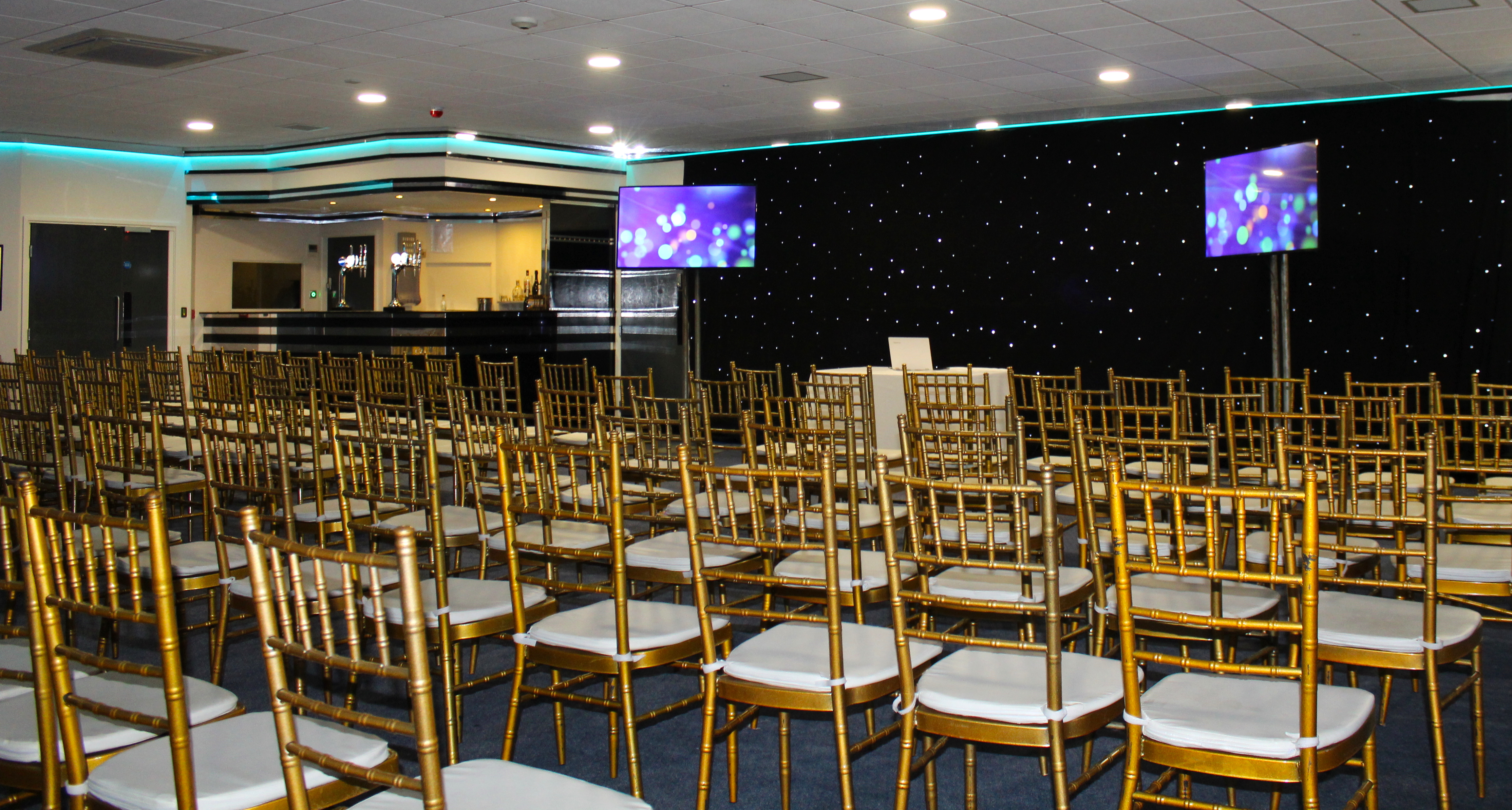 Elegant Silver Suite with gold chiavari chairs for corporate events and conferences.