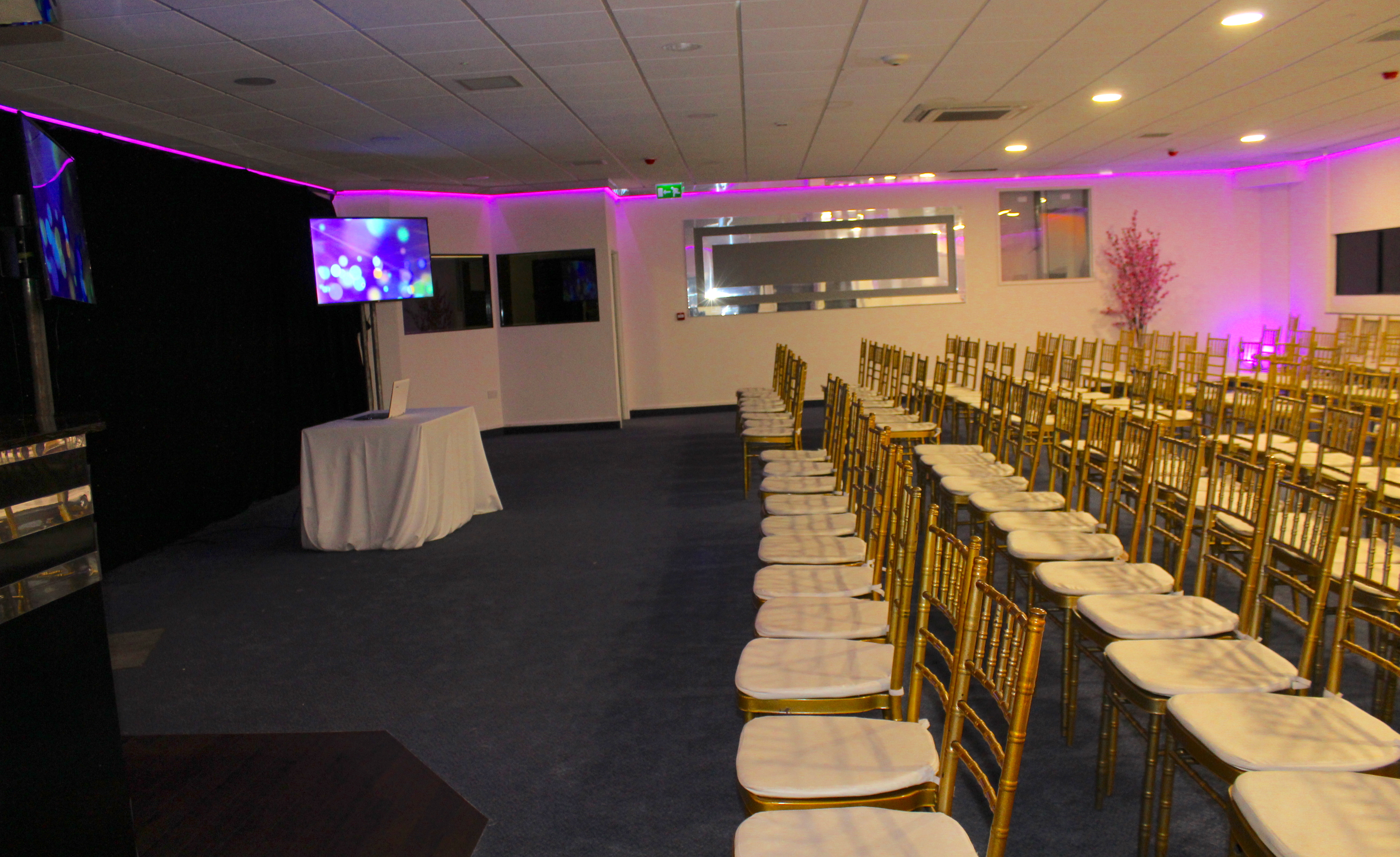 Elegant Silver Suite with gold chairs, perfect for conferences and seminars.