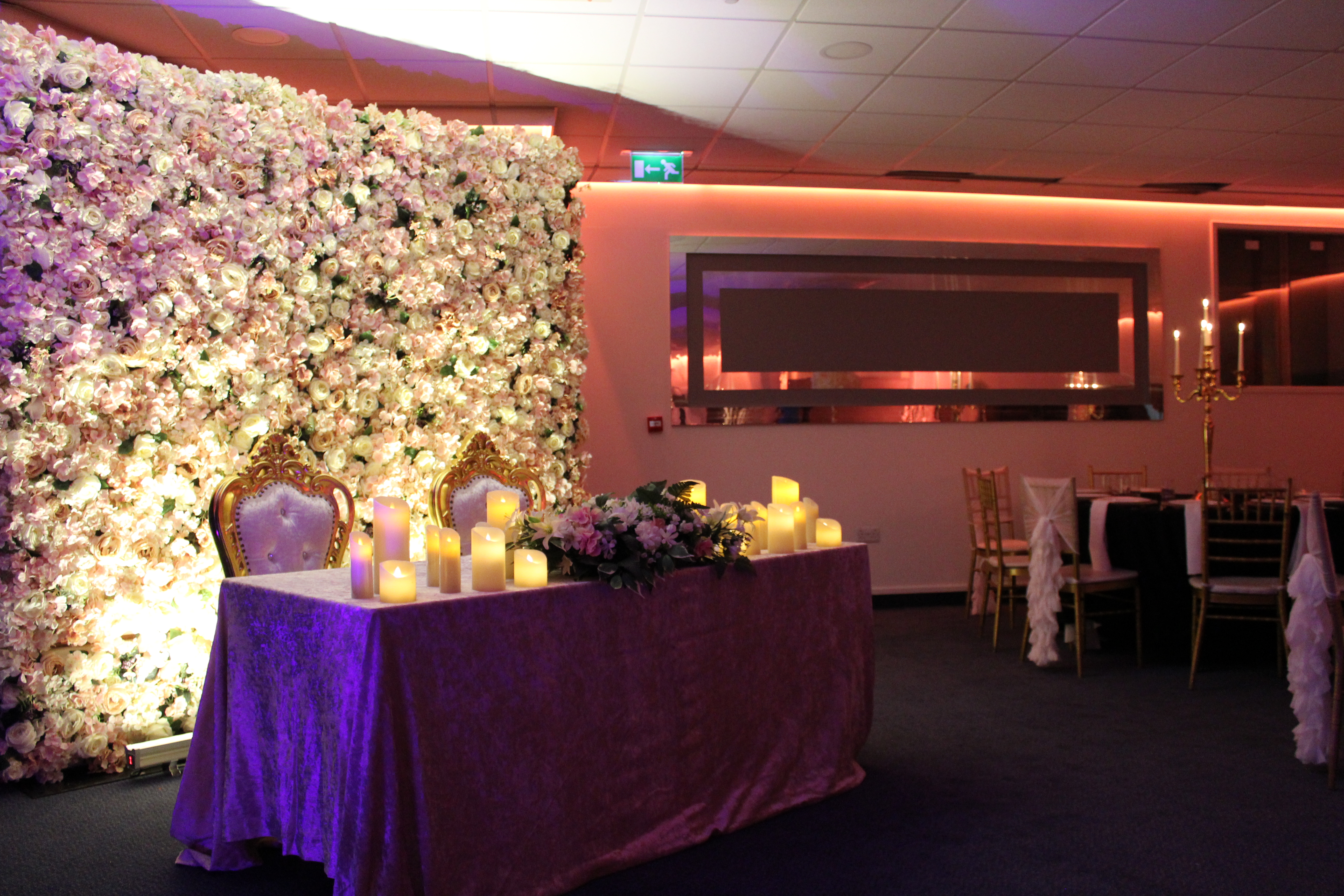 Elegant Silver Suite with floral backdrop, perfect for weddings and upscale events.