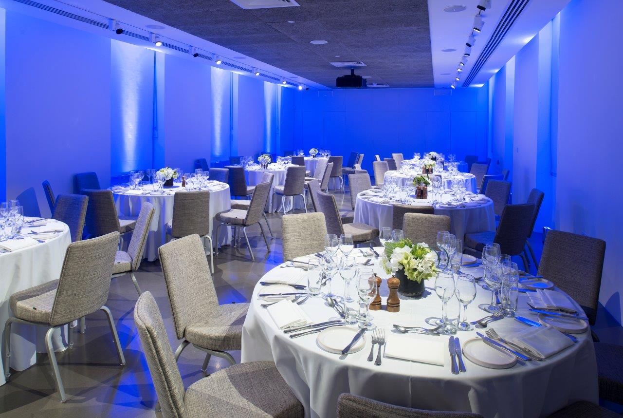 Elegant event space with round tables, ideal for corporate gatherings in Science Gallery London.