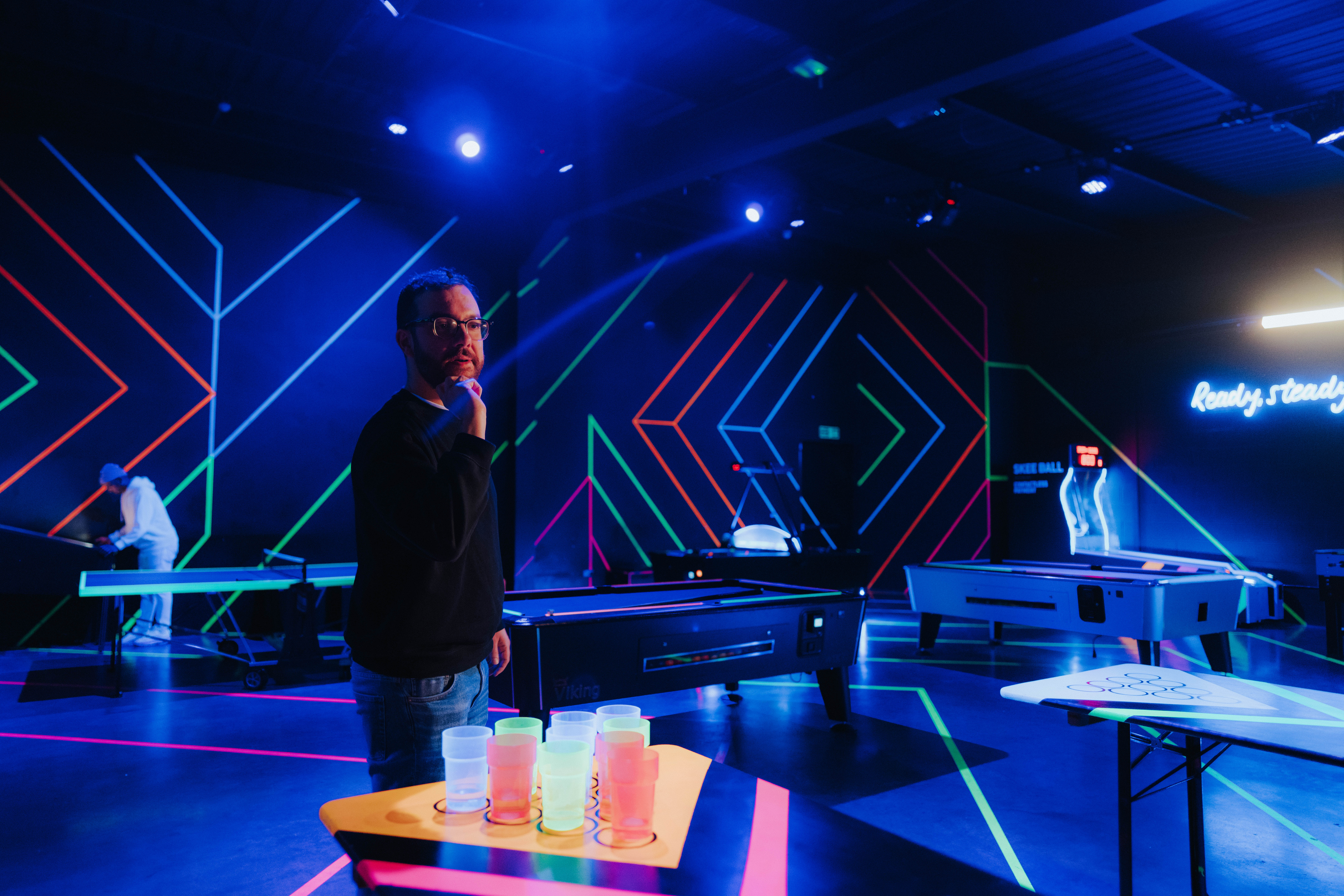 Playbox Room at Boxpark Wembley: vibrant event space with neon lights for networking and fun.