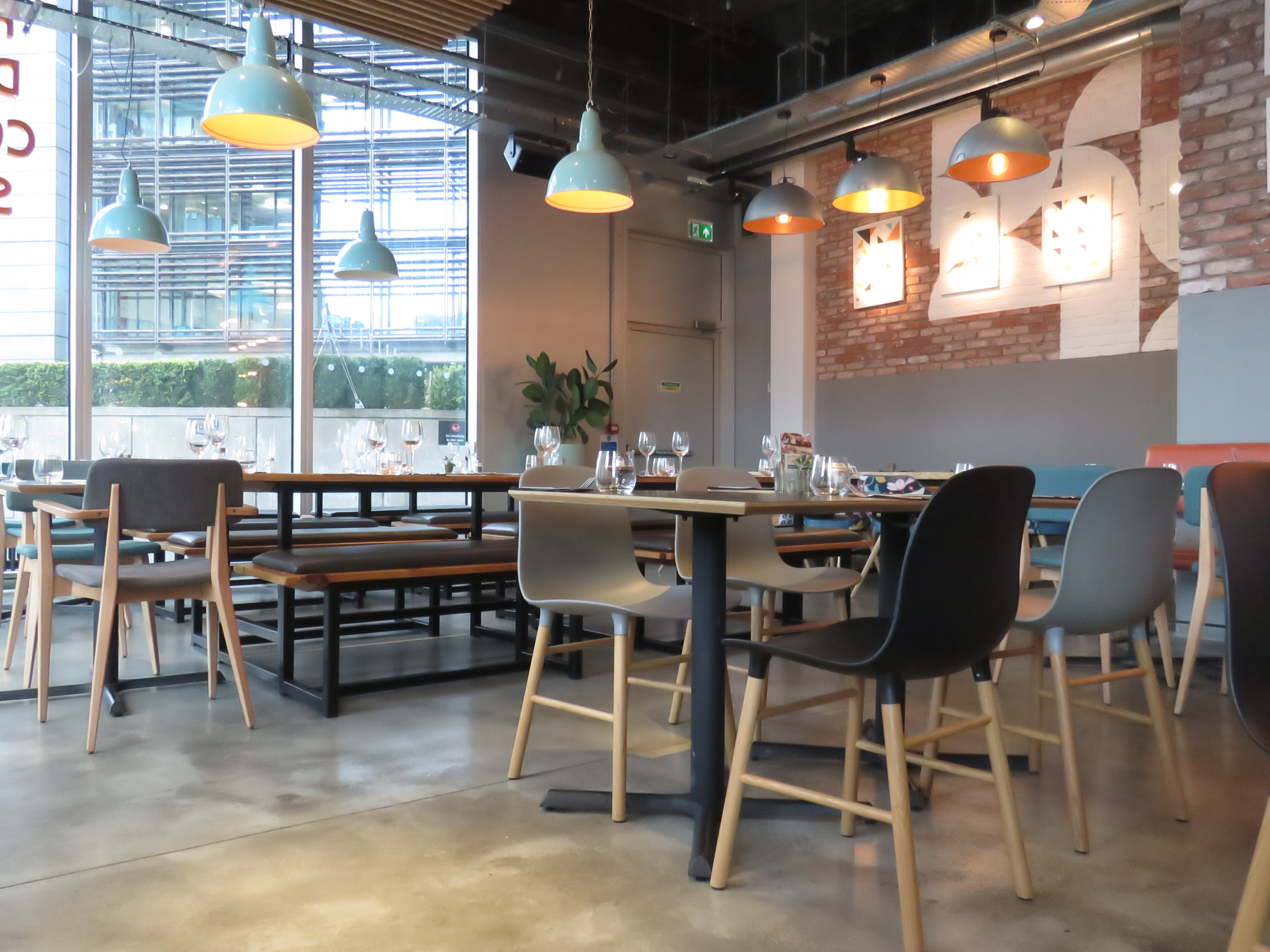 Modern dining space at KuPP with flexible seating for events and casual meetings.