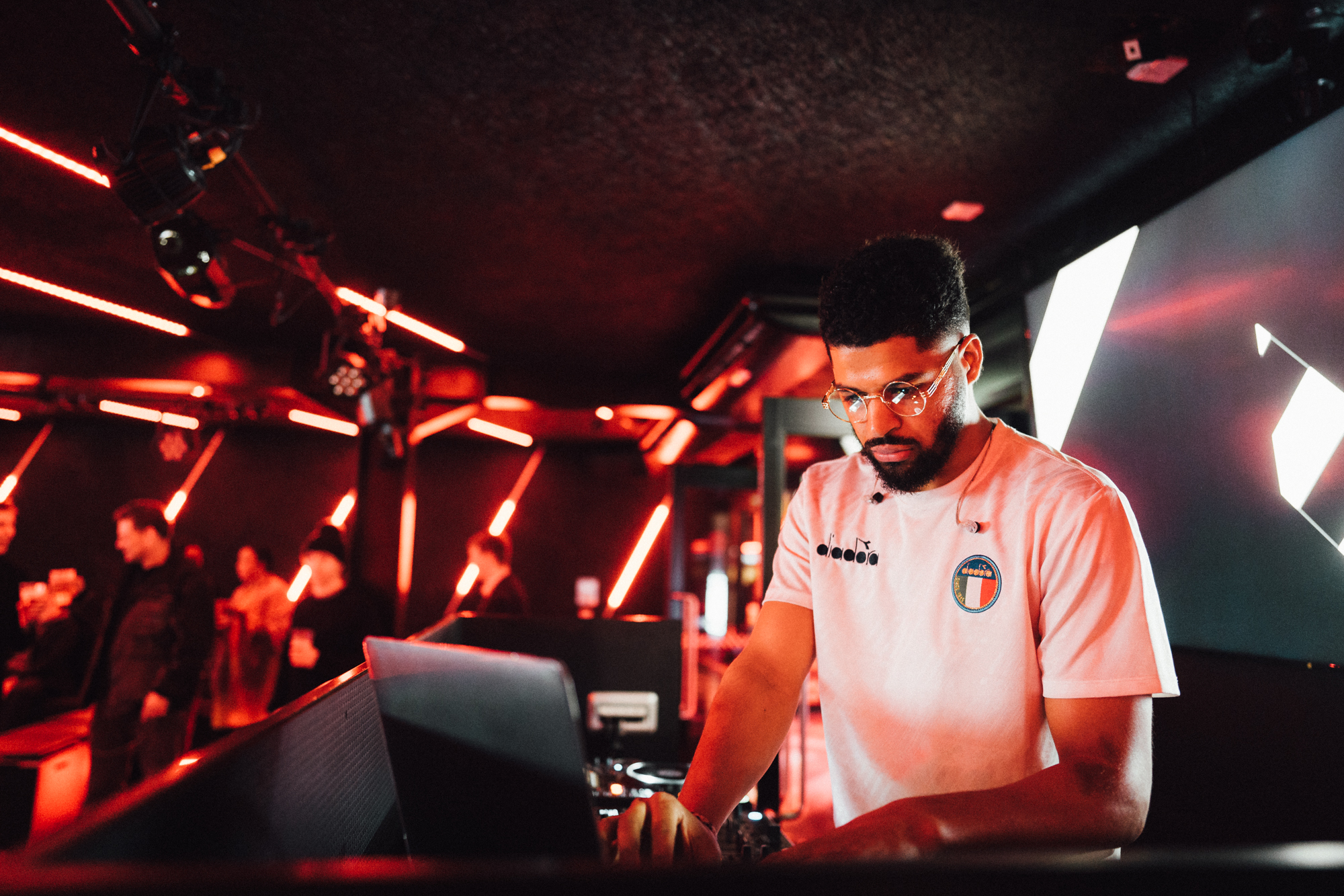 DJ at BeatBox, Boxpark Wembley, vibrant nightlife event with modern design.