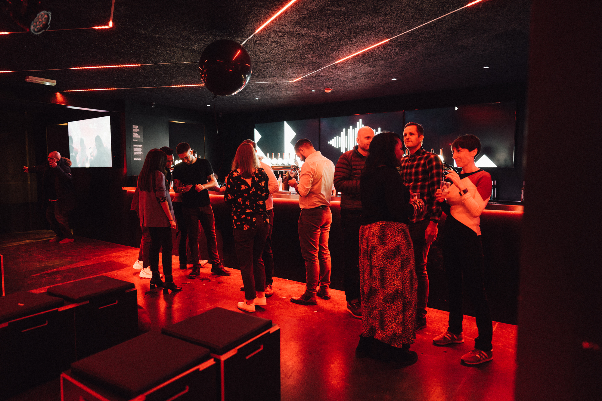 Vibrant networking event at BeatBox, Boxpark Wembley with stylish decor and mingling attendees.