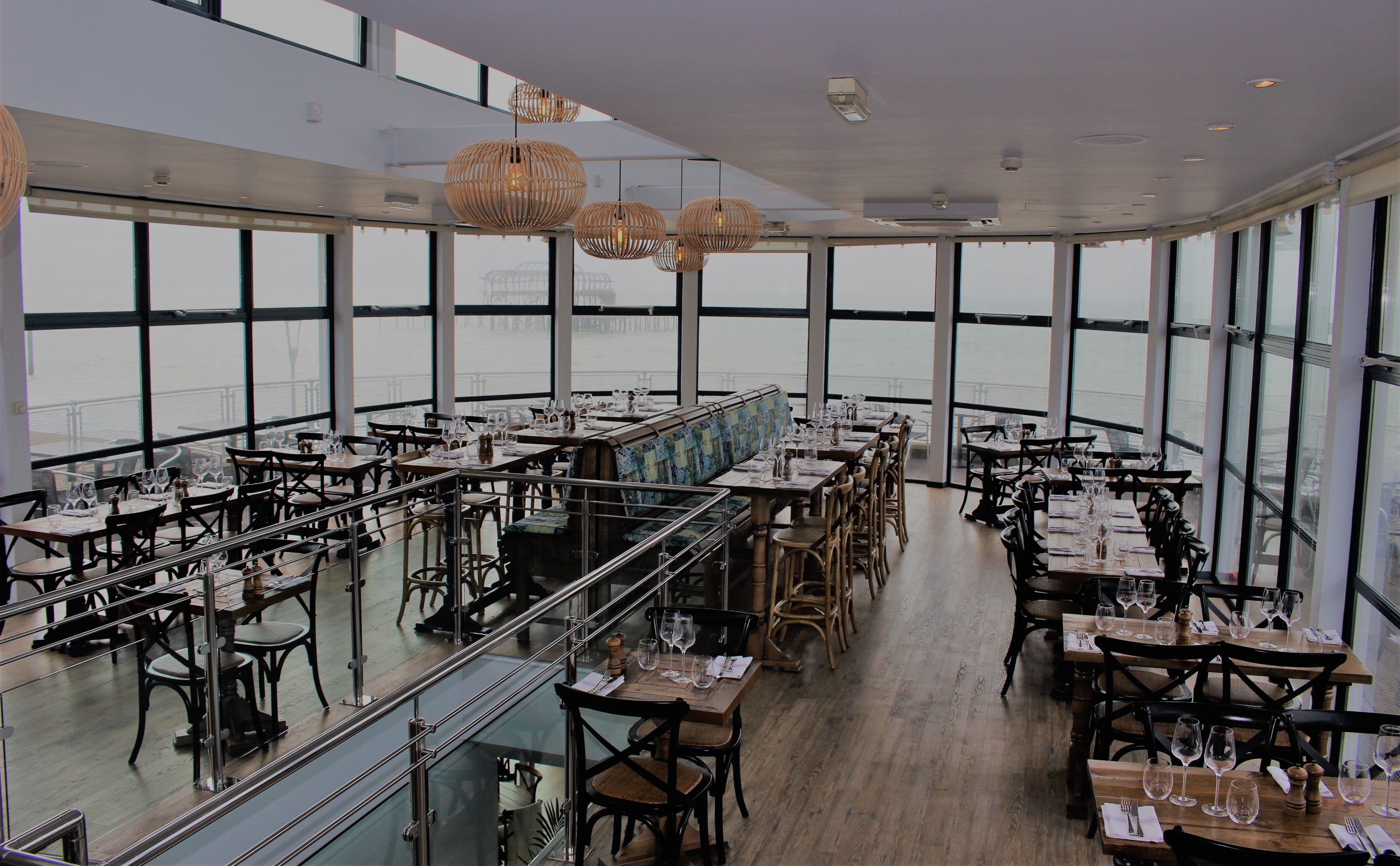 Elegant Brighton Beach Club restaurant with panoramic windows, perfect for events.
