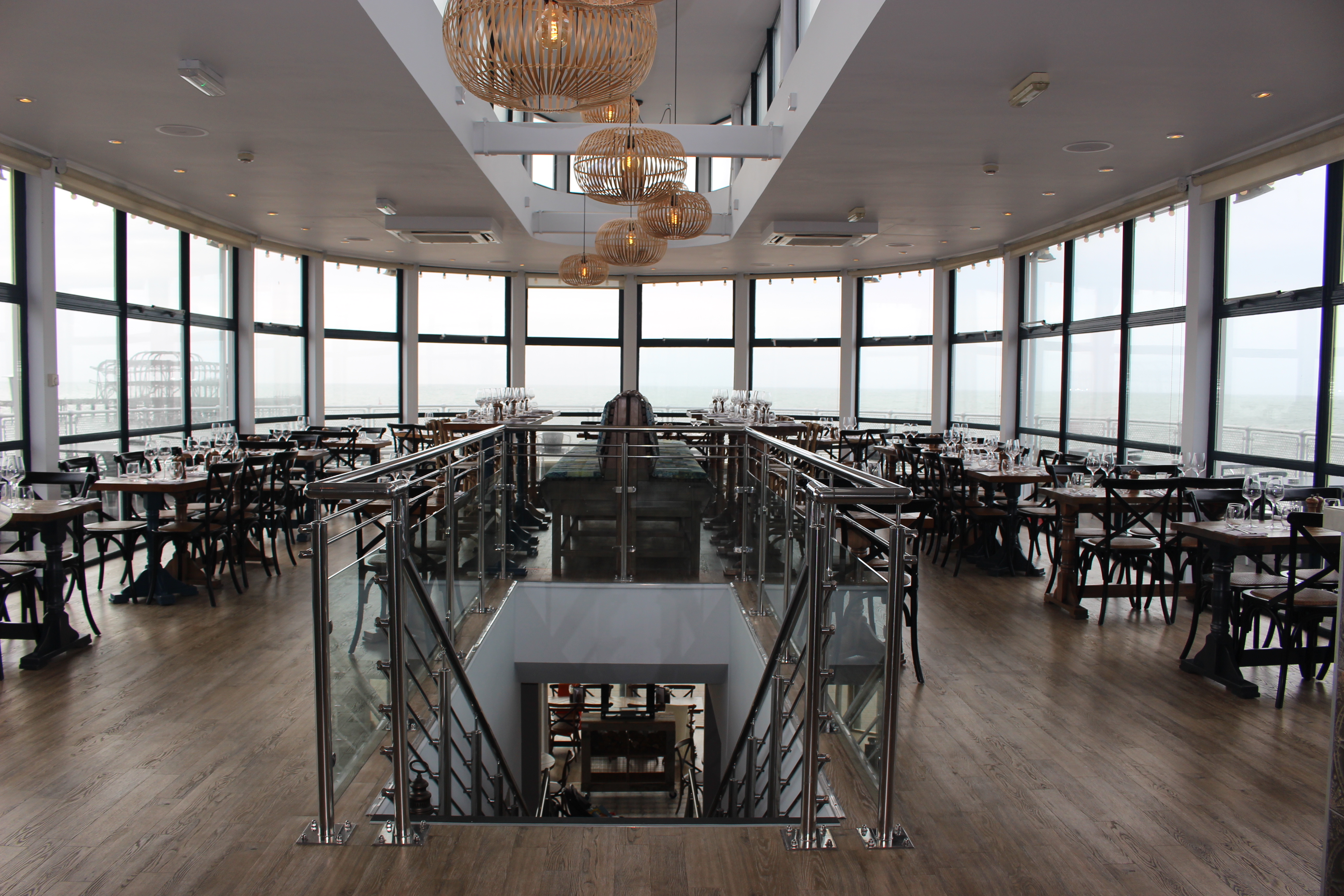 Modern event space with panoramic windows at Brighton Beach Club, ideal for gatherings.