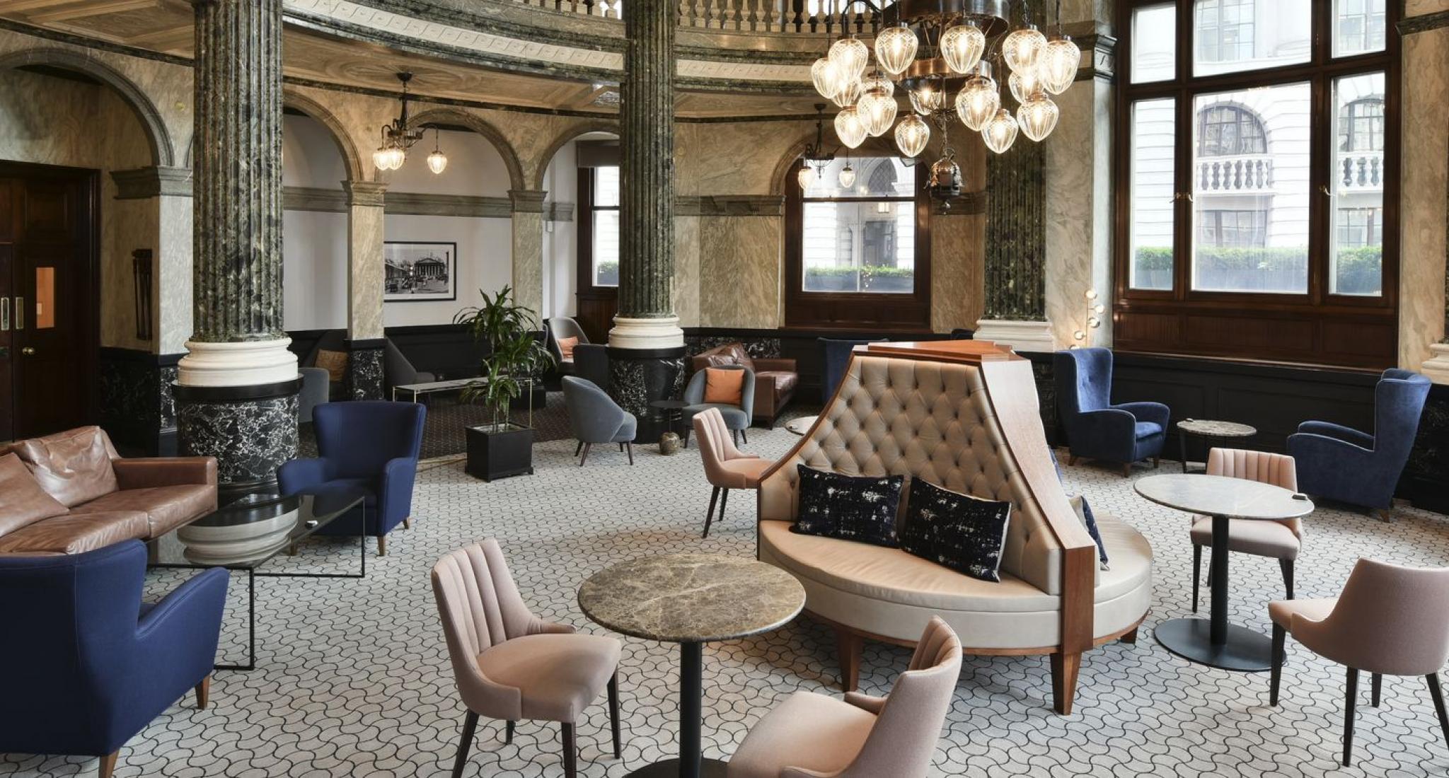 Sophisticated purple meeting room with plush seating for networking events.