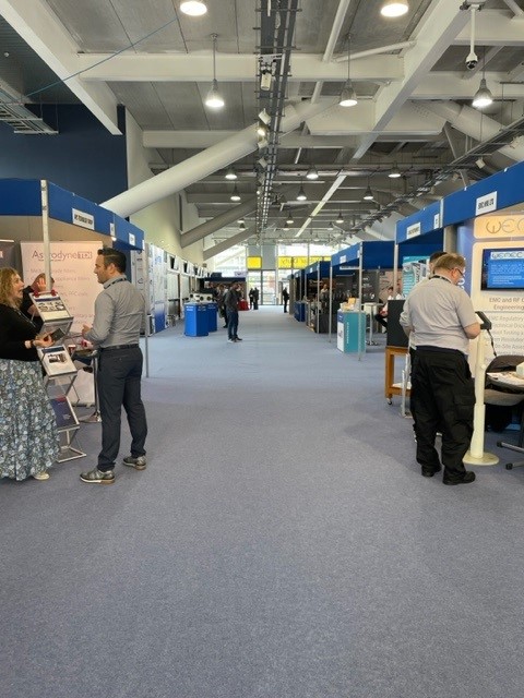 Grandstand at Newbury Racecourse, bustling exhibition hall for networking events.