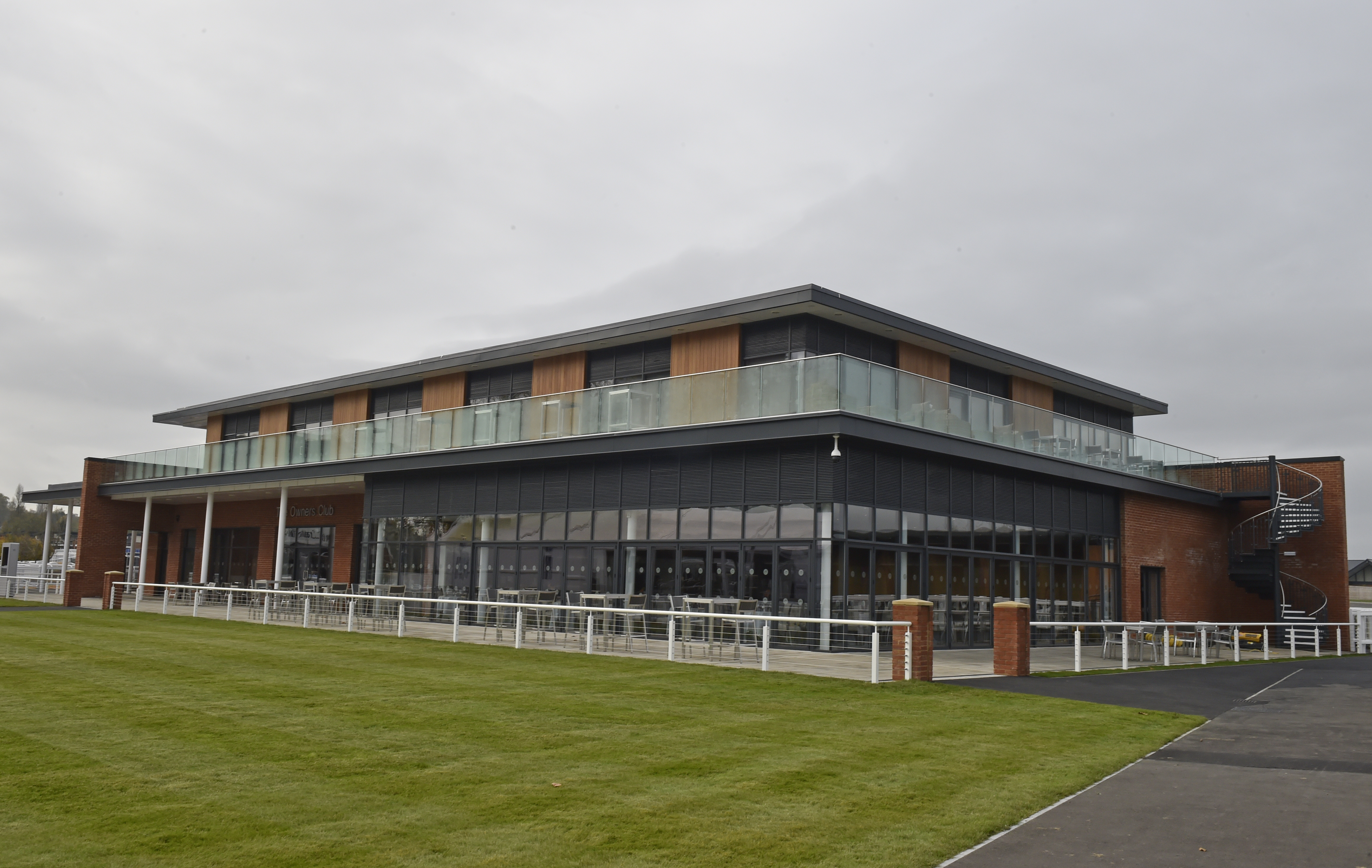 Modern event venue at Newbury Racecourse with large windows and outdoor space.