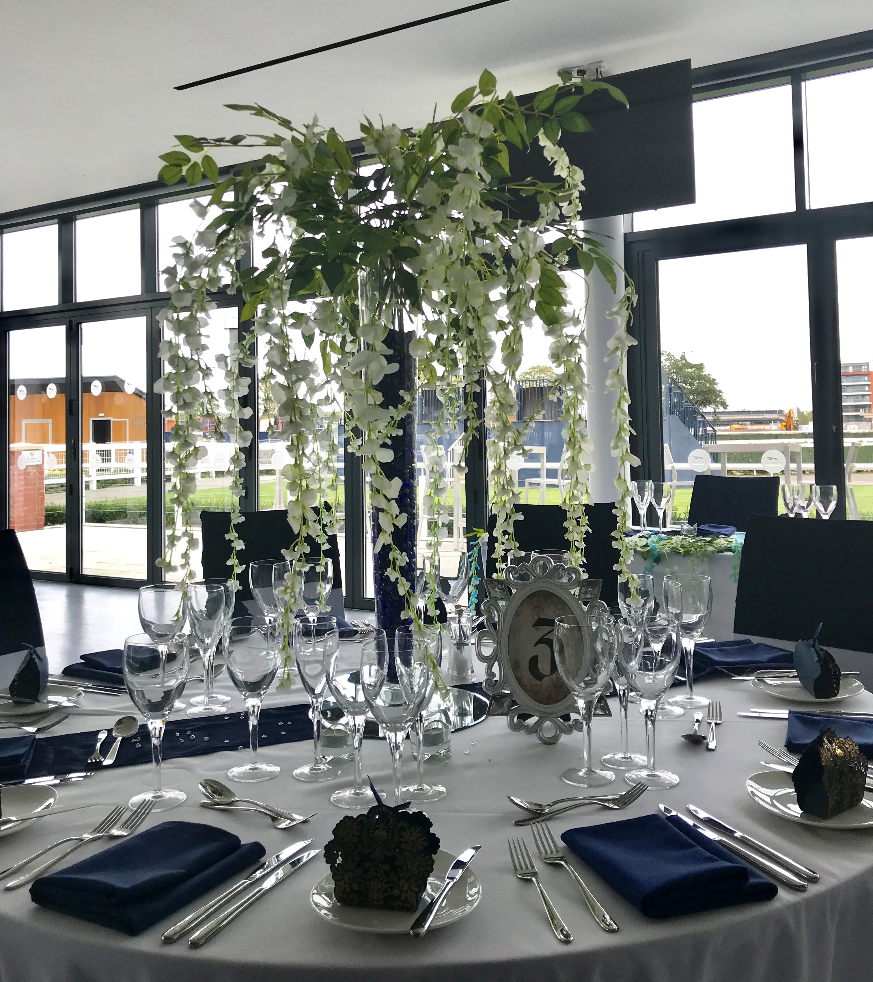 Elegant dining table with floral centerpiece at Newbury Racecourse for weddings and events.