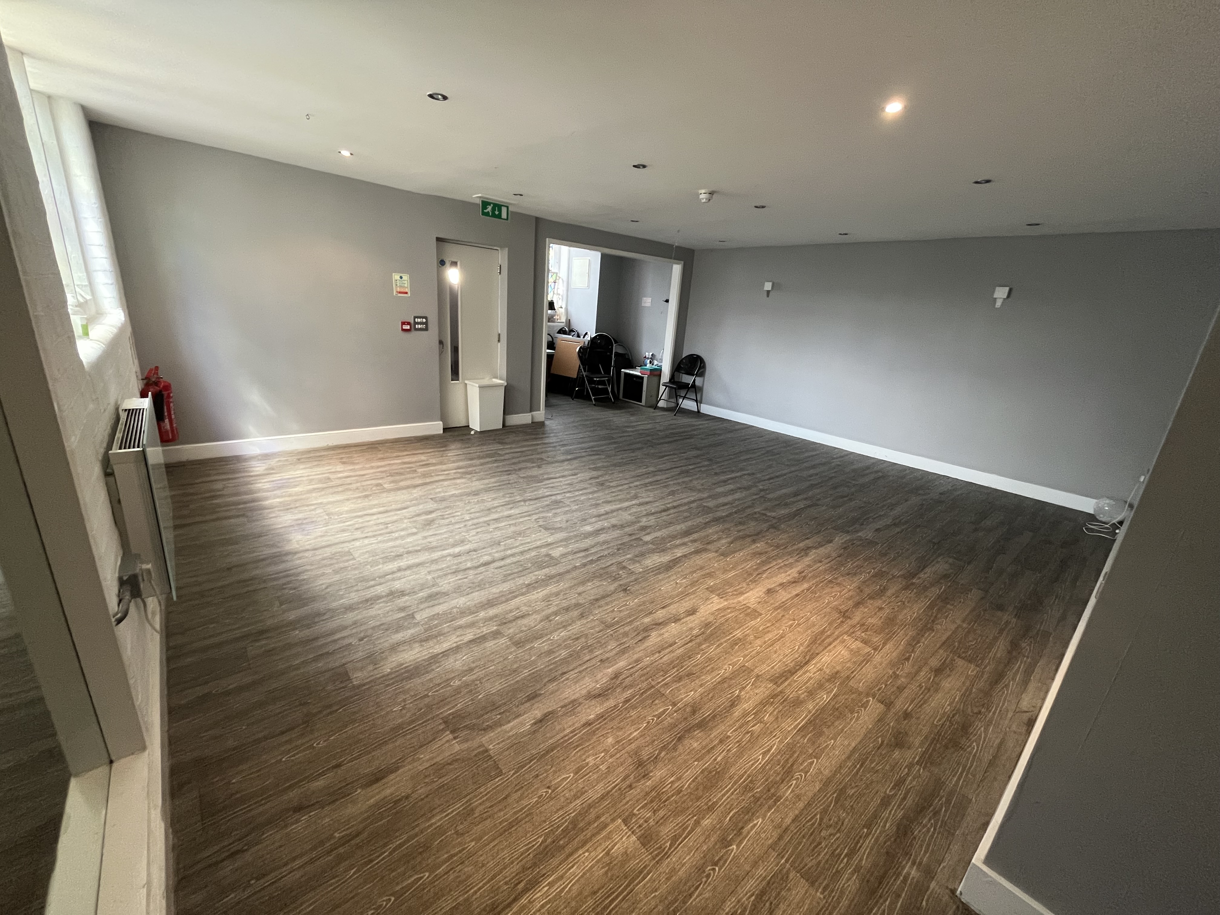 Versatile event space with gray walls, ideal for corporate meetings and social gatherings.