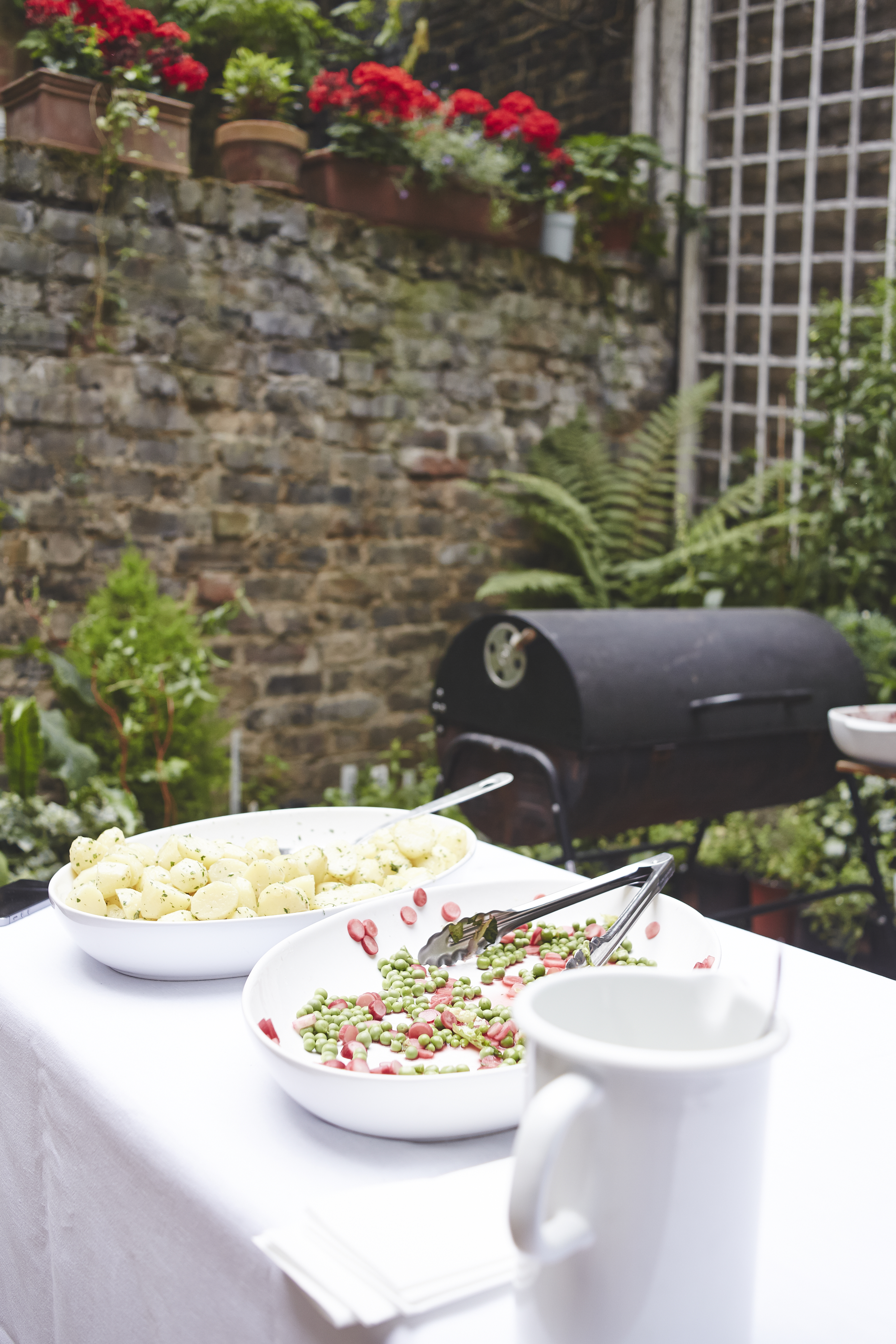 Outdoor catering setup with creamy potato salad and vibrant vegetable medley for summer events.