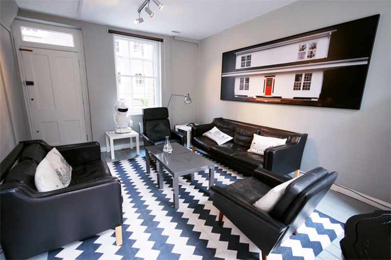 Modern meeting space with black leather sofas for collaborative brainstorming sessions.