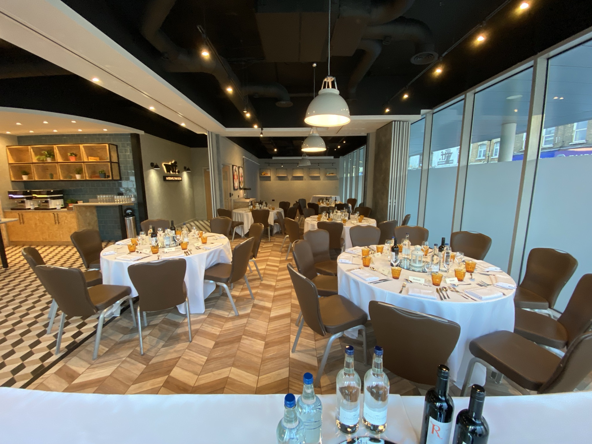 Whitechapel Think Factory event space with elegant round tables for networking or dining.