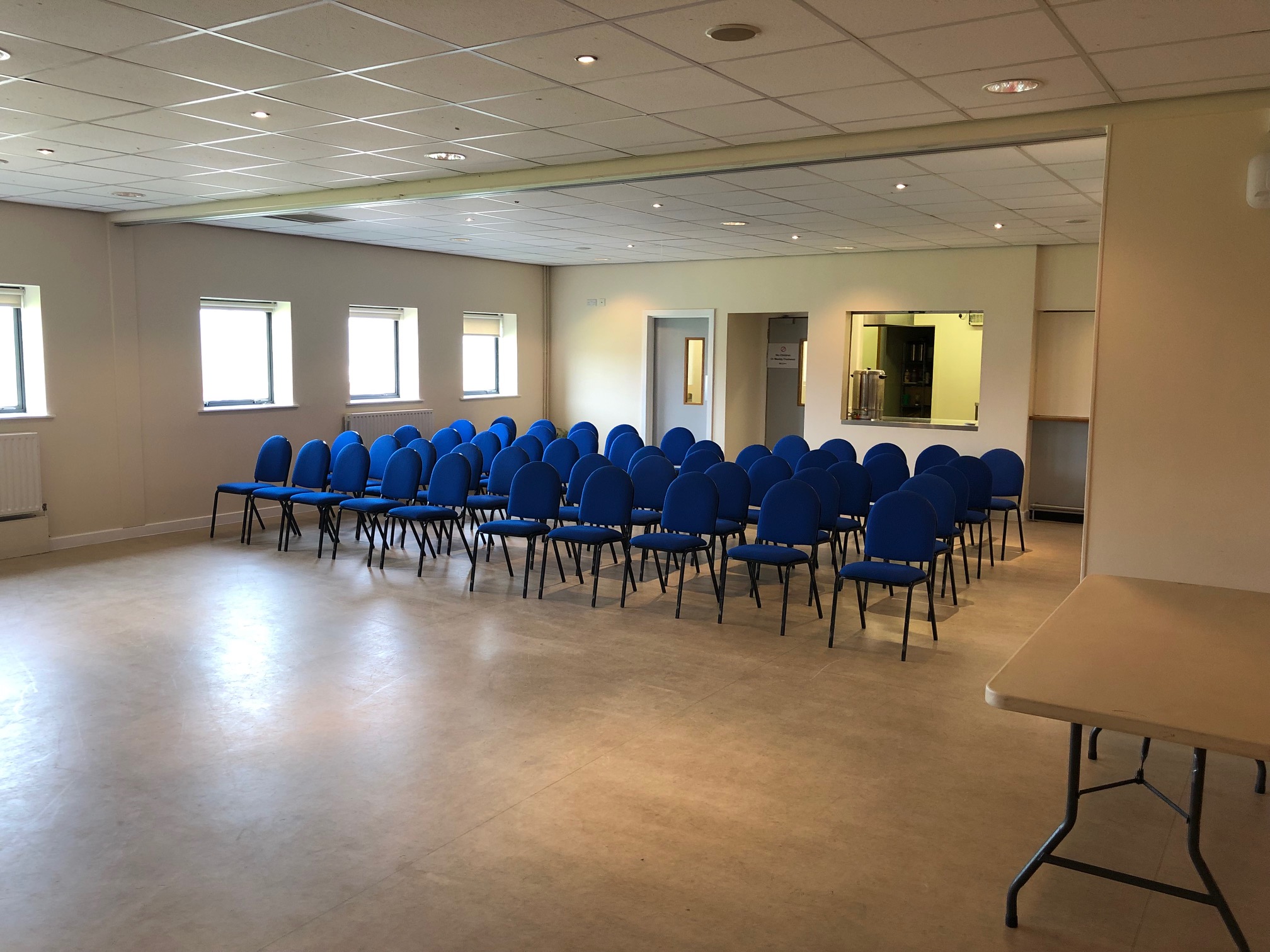 Versatile dining area with blue chairs for workshops at DRAM Training Centre, Huddersfield.
