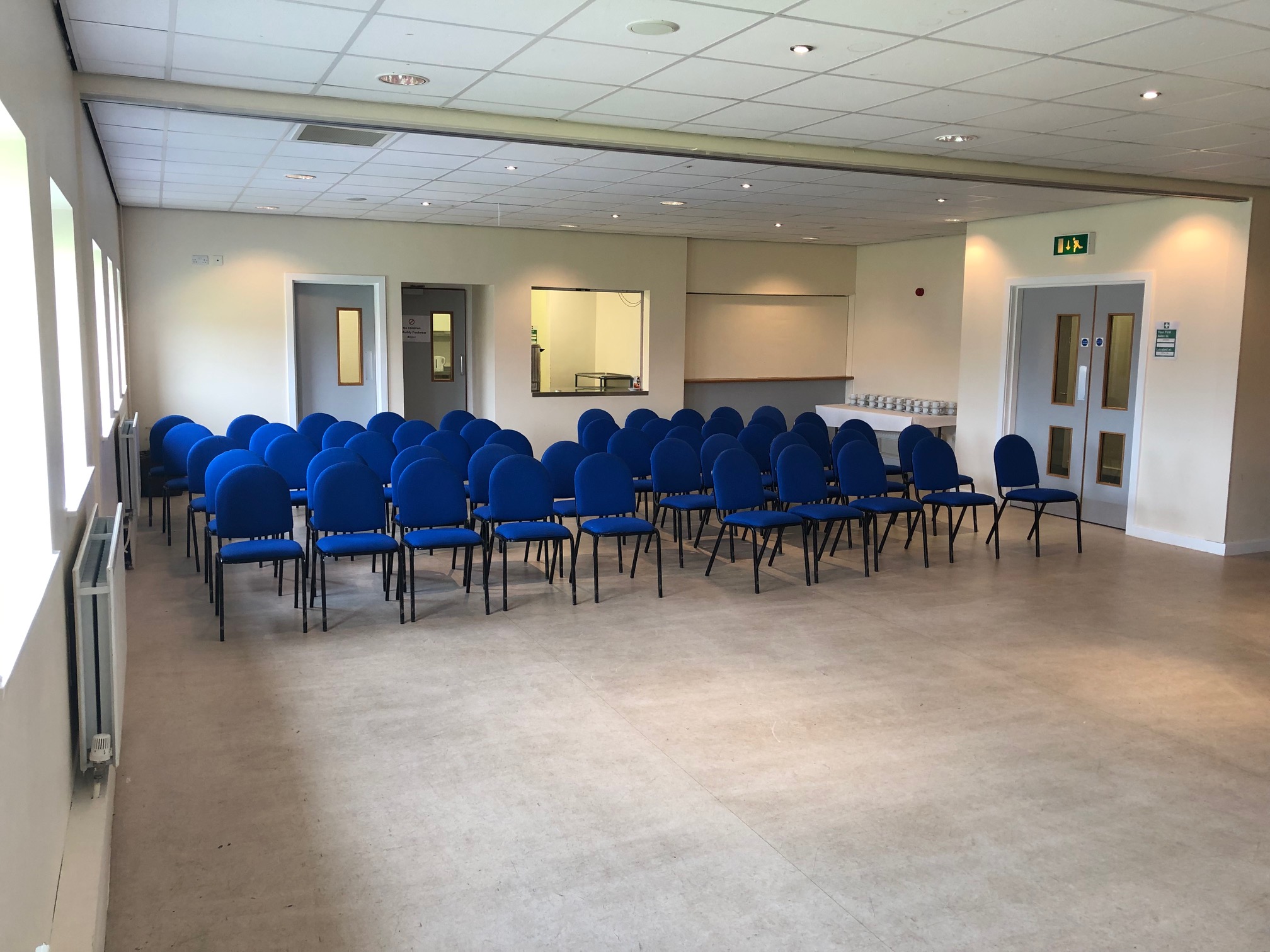 Versatile dining area with blue chairs for conferences and workshops in Huddersfield.