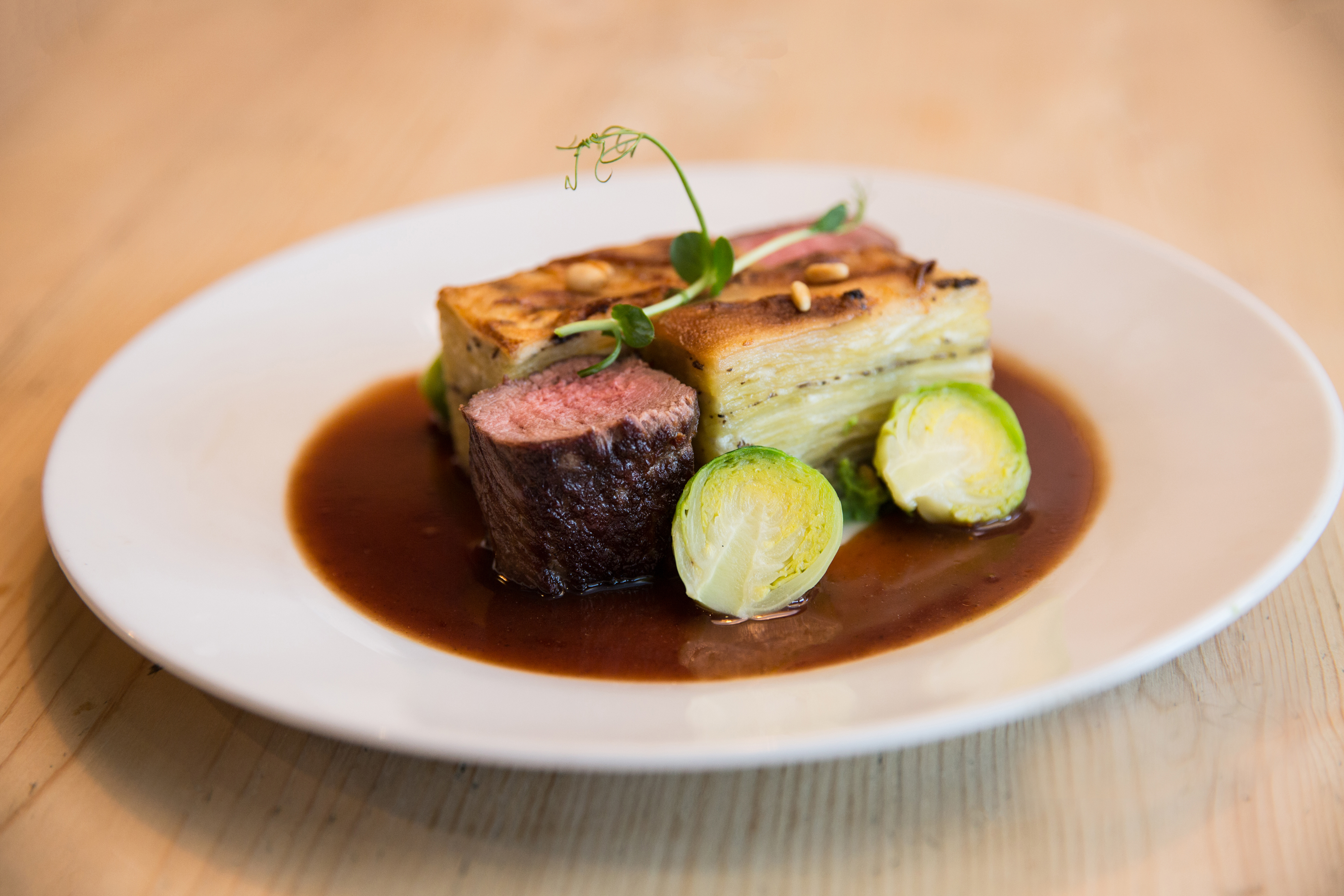 Succulent meat dish with Brussels sprouts at Stein's Berlin Restaurant event.