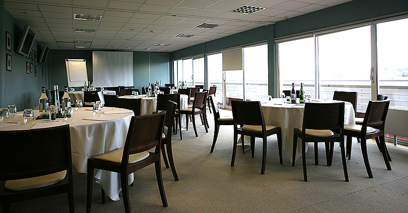 Berkshire Stand meeting space with round tables for corporate events at Newbury Racecourse.