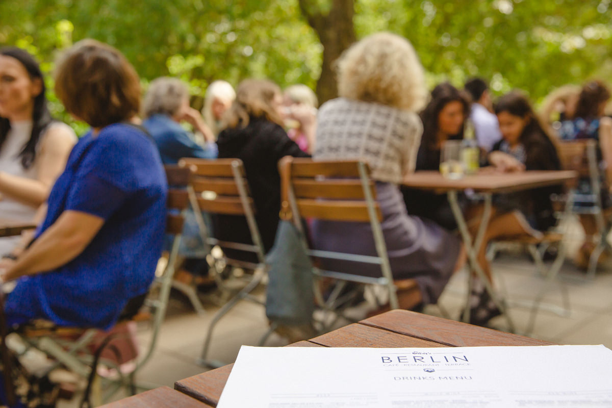 Outdoor networking event at Stein's Berlin Restaurant Terrace with engaged attendees.