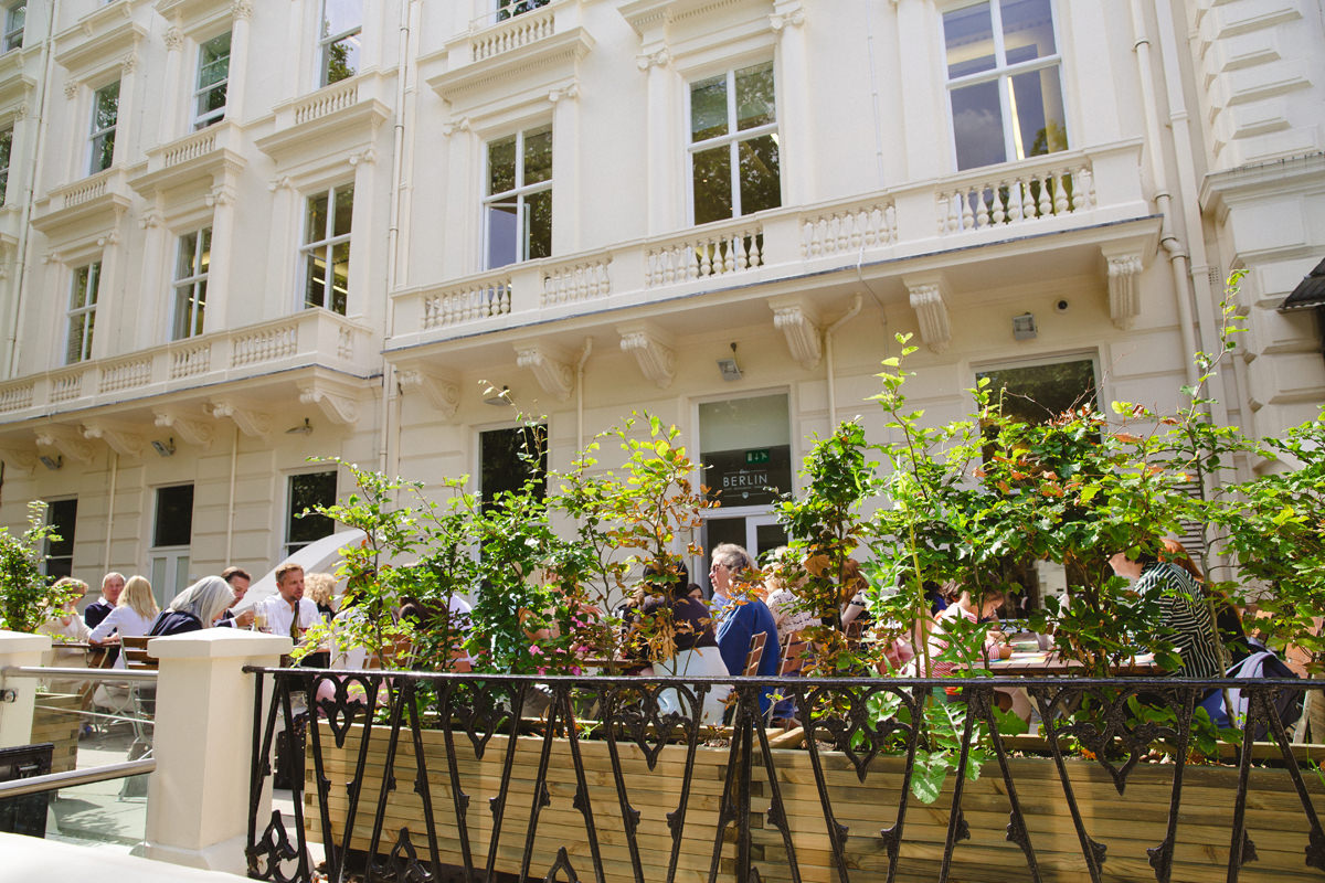 Outdoor event space at Stein's Berlin Restaurant with lush greenery for summer gatherings.
