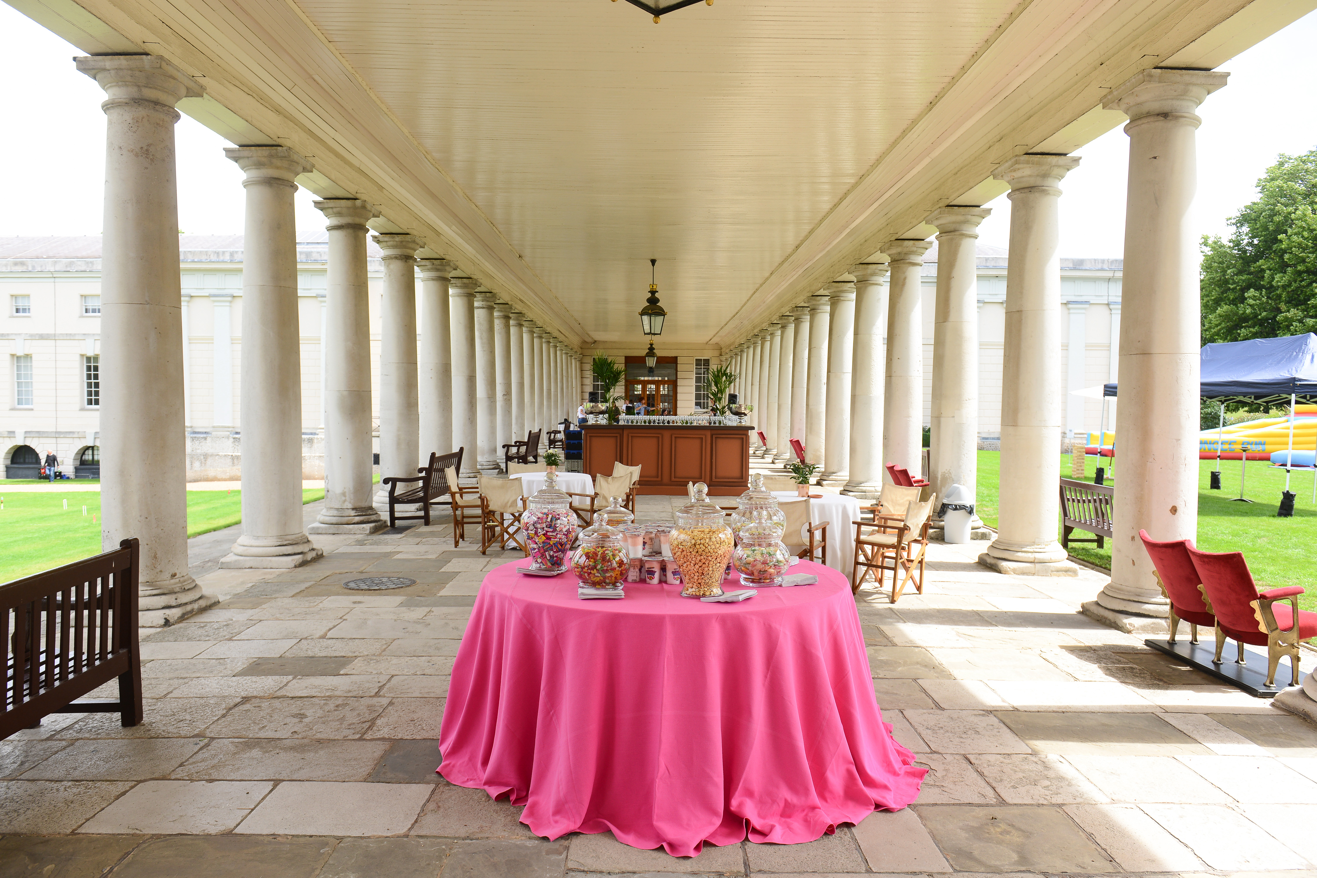 Outdoor event venue at South Lawns, The Queen's House with vibrant pink tablecloth.