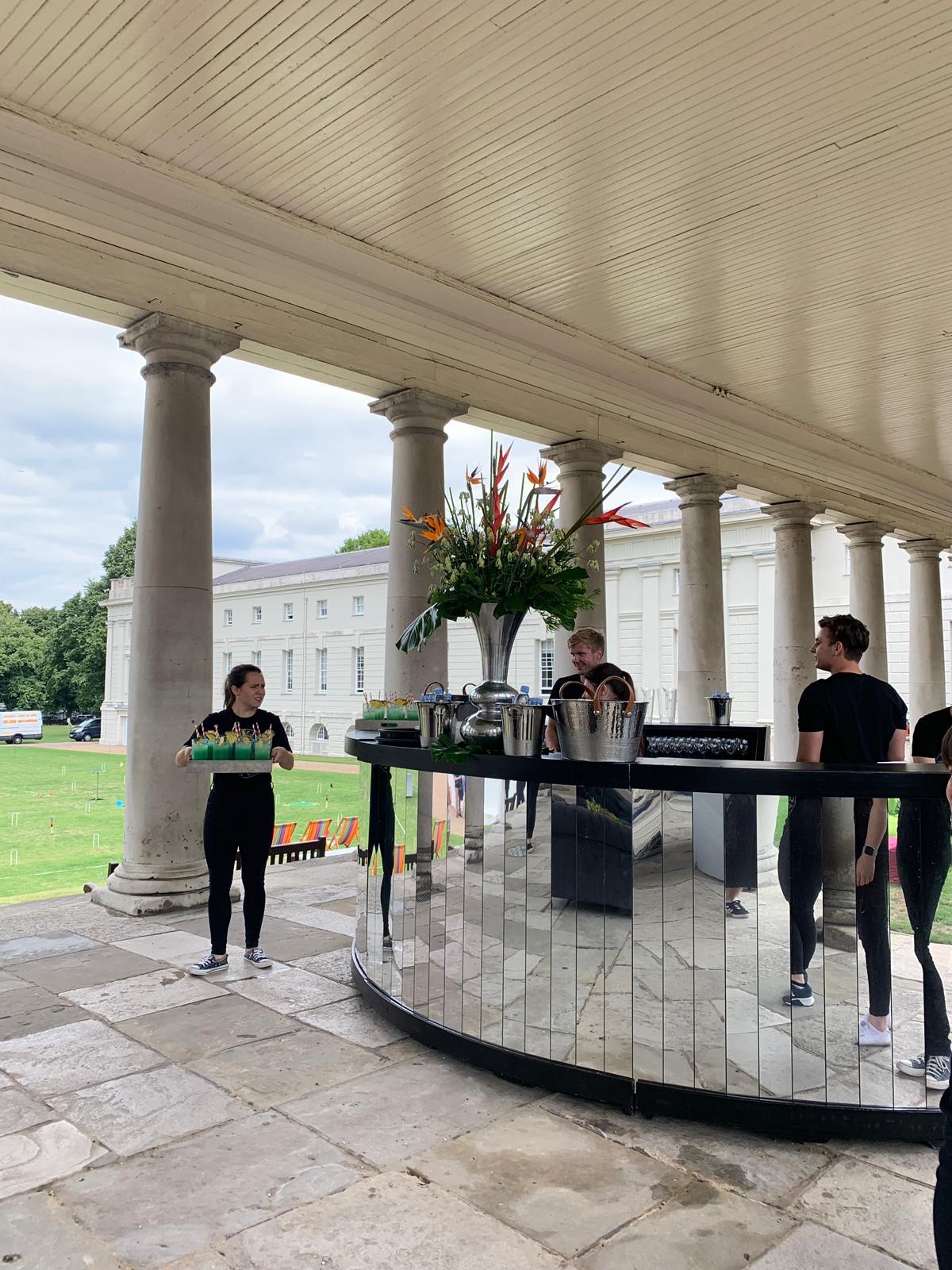 Elegant outdoor event at South Lawns, The Queen's House with stylish bar setup.