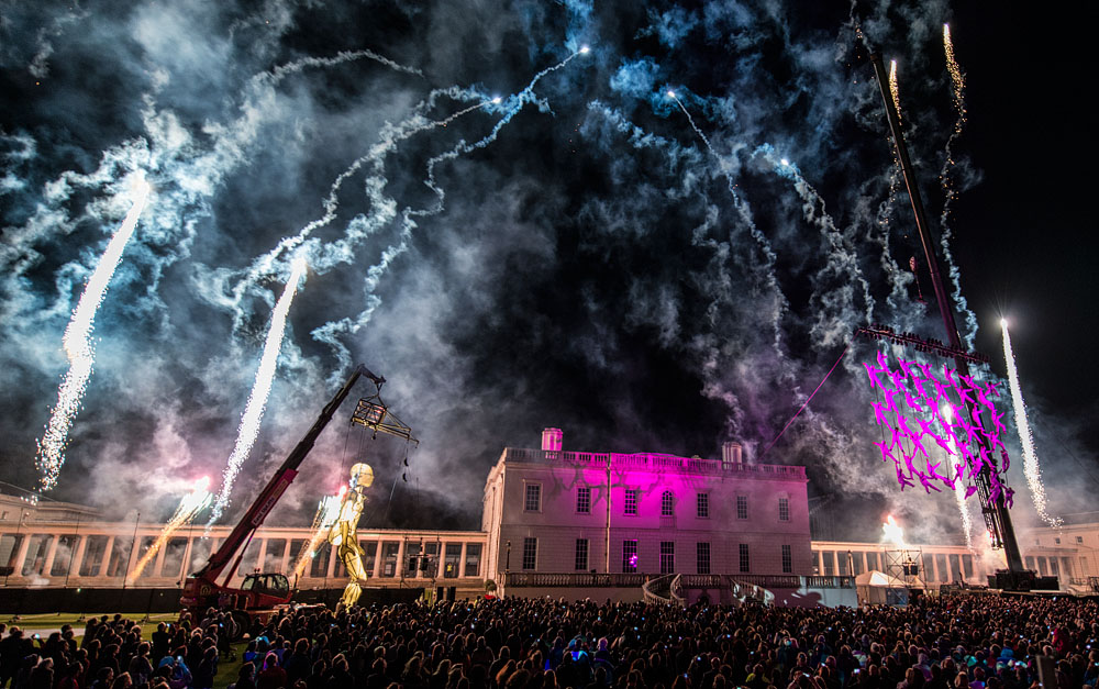 Vibrant outdoor festival at South Lawns, The Queen's House with fireworks and historic architecture.