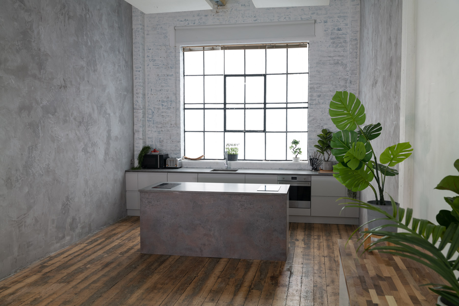 Modern minimalist kitchen with natural light, perfect for wellness events and cooking classes.