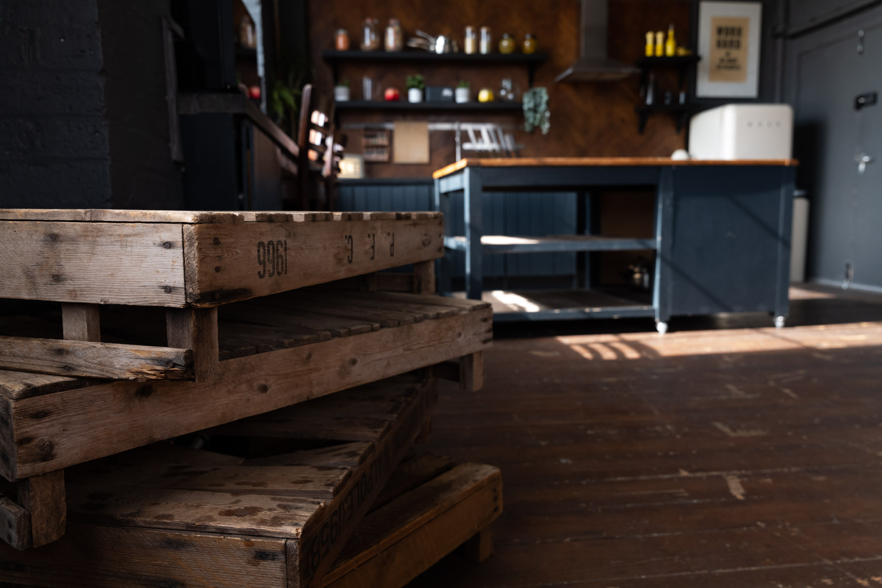 Crixus Dockyard Kitchen: rustic event space with wooden pallets for cooking workshops.