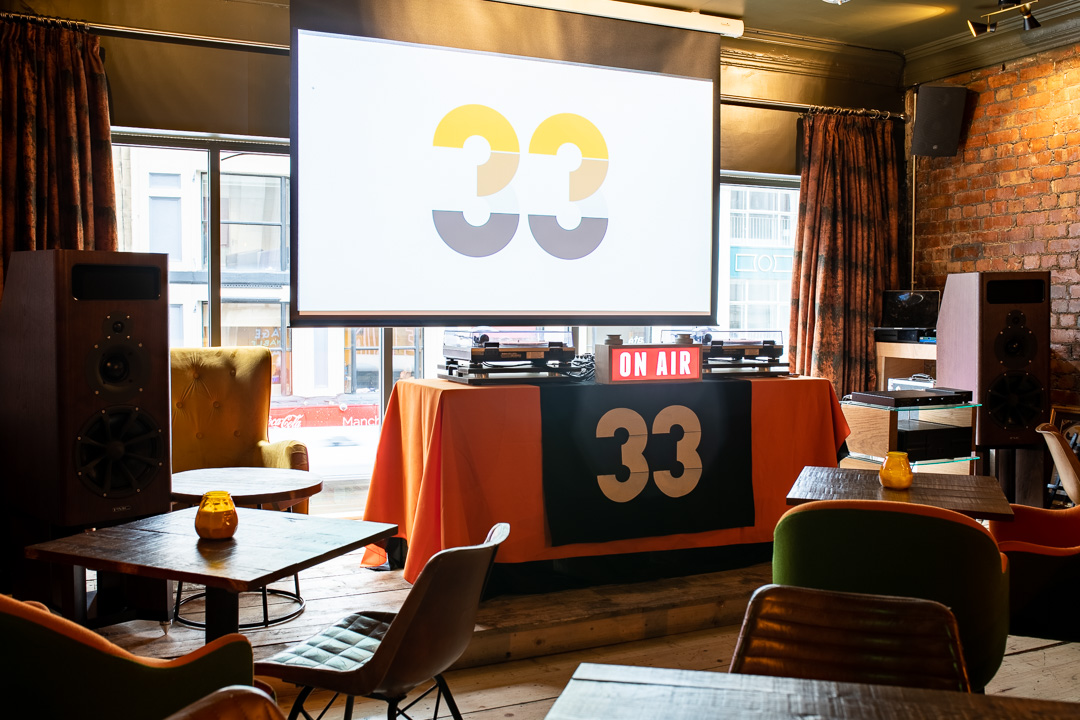 Stylish event space at 33 Oldham Street with logo screen, perfect for presentations and gatherings.