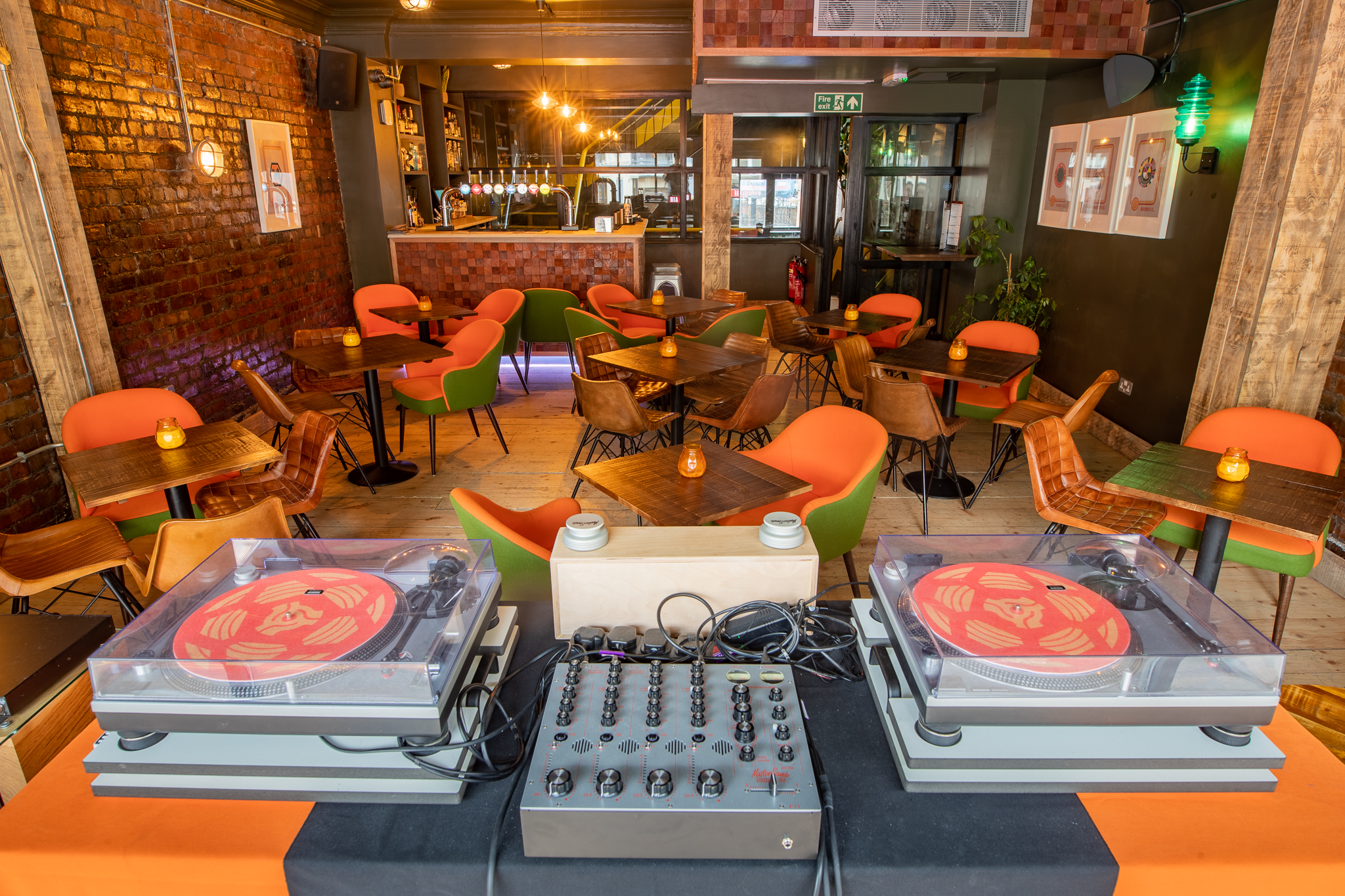 Vibrant event space with stylish bar, ideal for DJ performances and social gatherings.