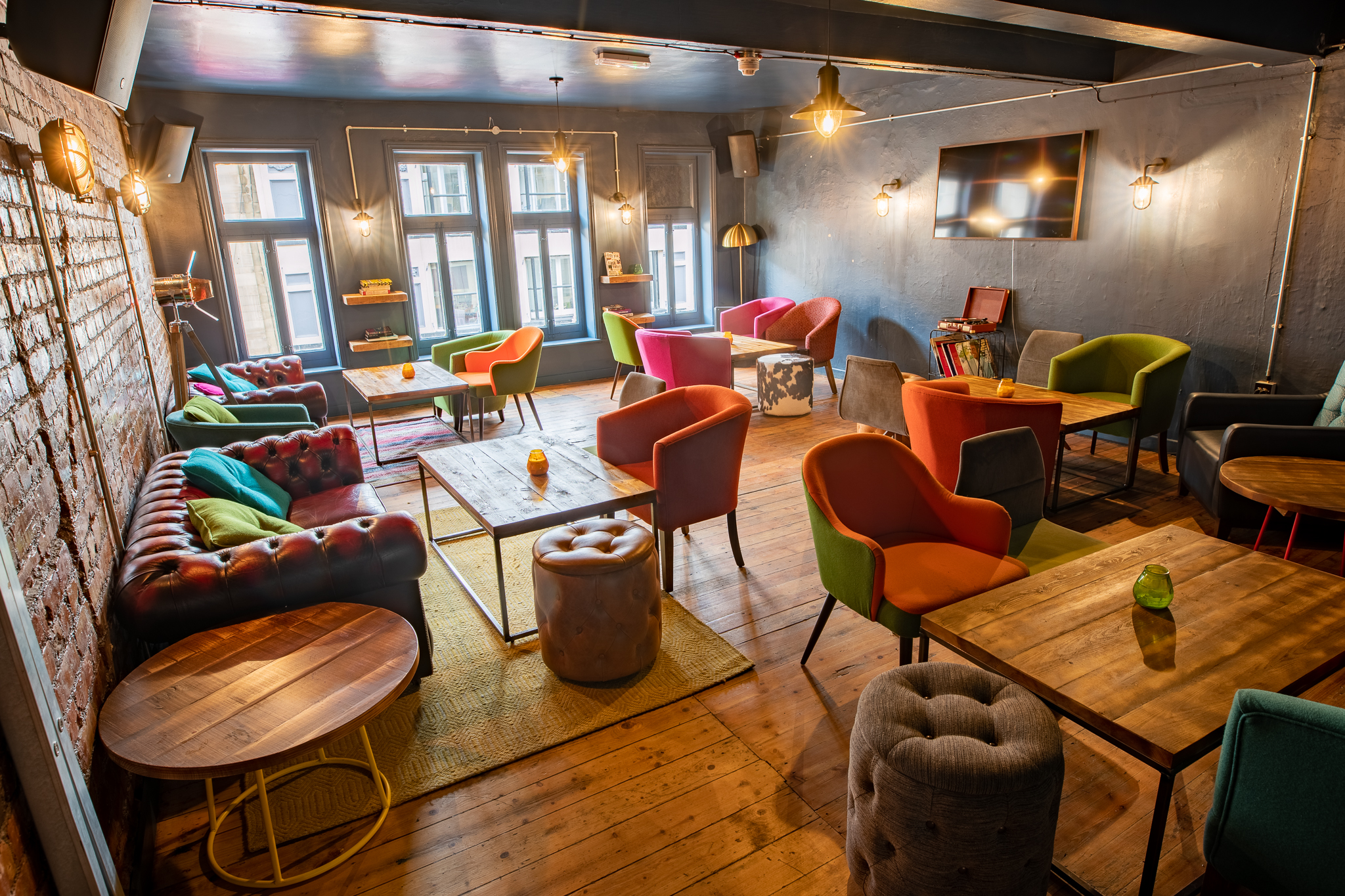 Vibrant lounge space with colorful seating for networking events at 33 Oldham Street.