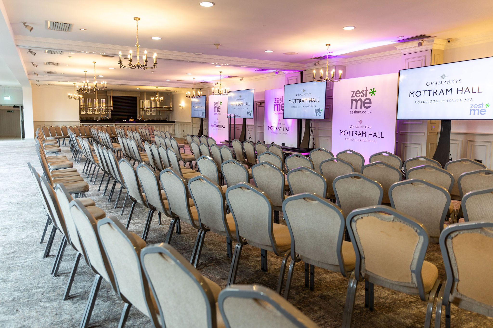 St Andrews Suite at Mottram Hall, ideal for conferences with arranged chairs and screens.